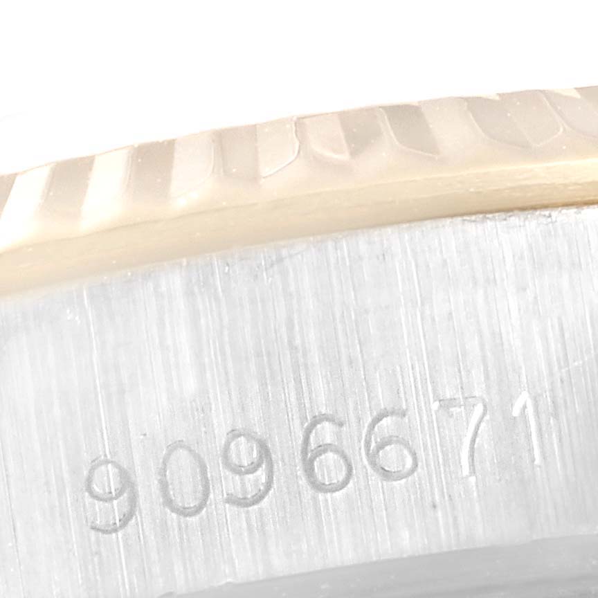 The image shows a close-up of the serial number engraving on the side of the case for a Rolex Datejust 69173 Women
s Steel and Gold (two tone) Champagne Dial 69173 Women
s Steel and Gold (two tone) Champagne Dial watch.
