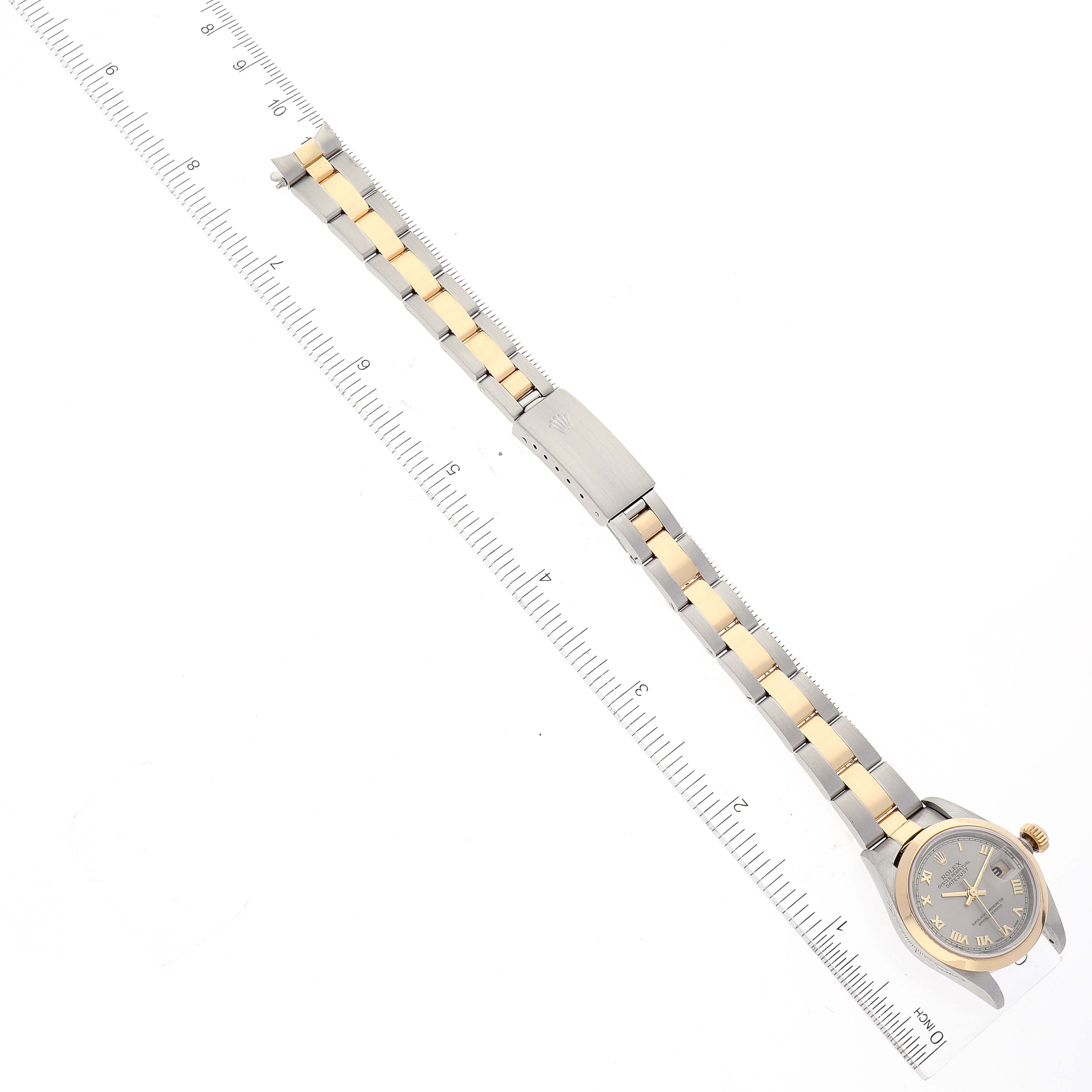 The image shows a Rolex Datejust 79163 Women's Steel and Gold (two tone) Grey Dial 79163 Women's Steel and Gold (two tone) Grey Dial watch laid flat with a ruler, displaying its bracelet and dial.