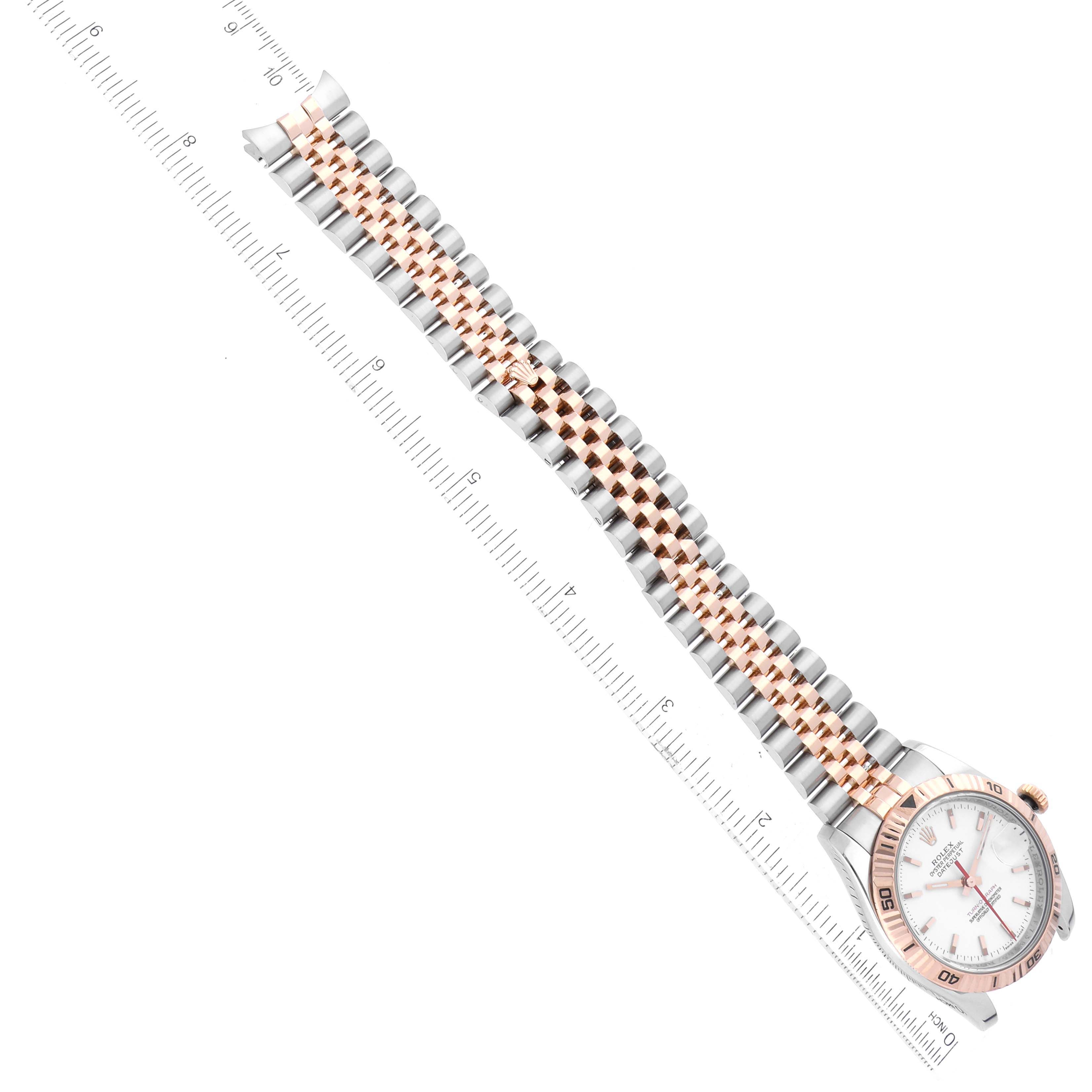 The Rolex Turn-o-Graph 116261 Men's Steel and Gold (two tone) White Dial watch is shown from a top view, displaying the full band and face next to a ruler for scale.
