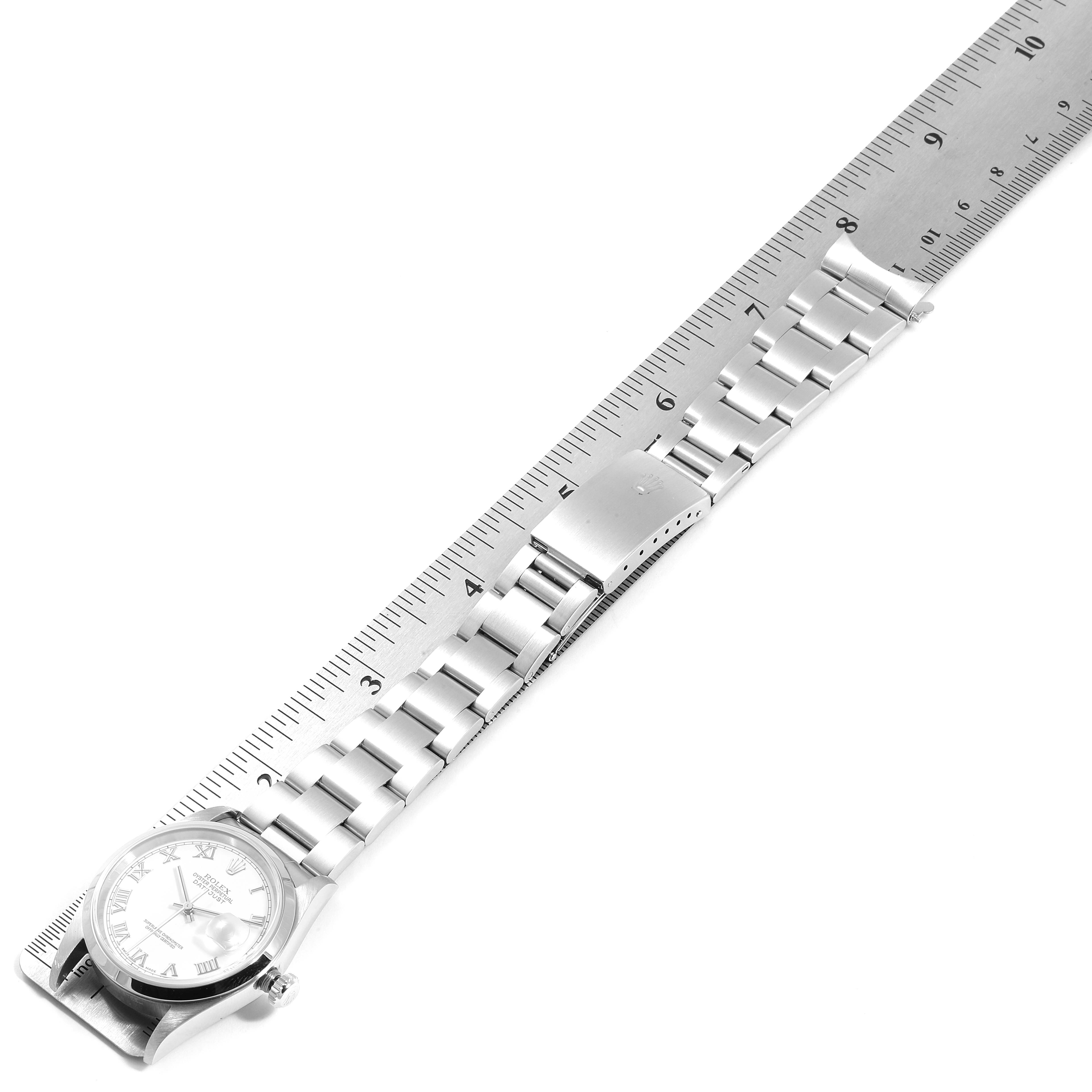 The image shows a Rolex Datejust 16200 Men's Stainless Steel White Dial 16200 Men's Stainless Steel White Dial watch laid flat alongside a ruler, displaying the dial and bracelet in a top-down view.