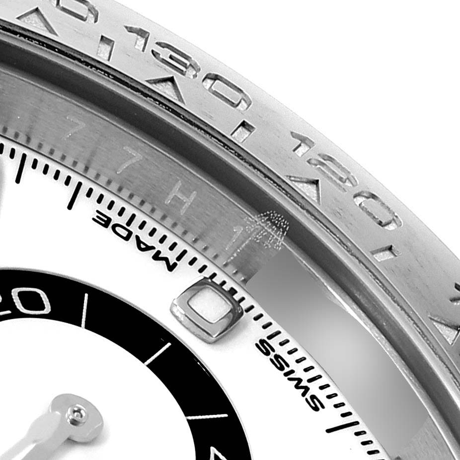 This image shows a close-up of the bezel and part of the dial of a Rolex Daytona 116500 Men's Stainless Steel White Dial 116500 Men's Stainless Steel White Dial watch.