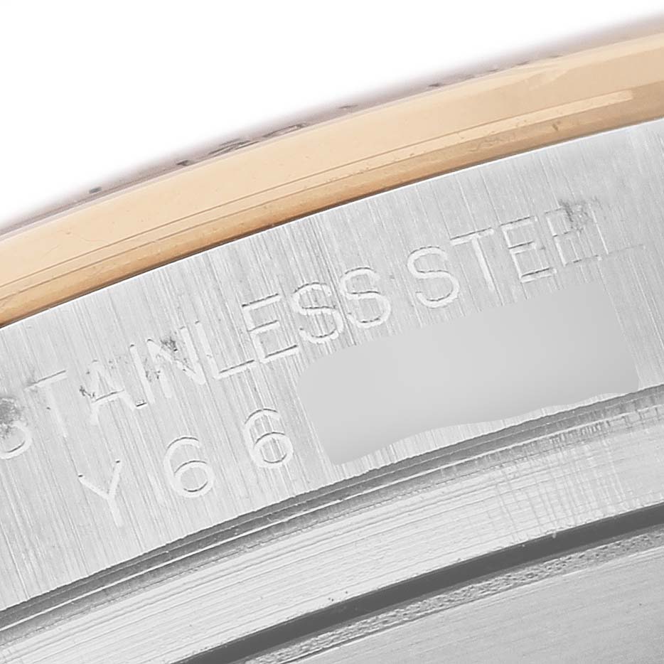 The image shows a close-up of the side engraving on a Rolex Daytona 116523 Men's Stainless Steel White Dial, indicating "STAINLESS STEEL."
