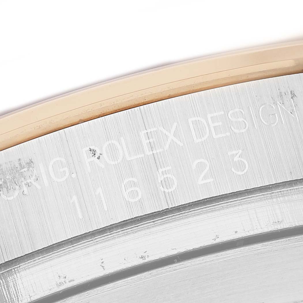 This close-up image shows the edge of the case back with engravings of the Rolex Daytona 116523 Men's Stainless Steel White Dial model, featuring the serial and model numbers.