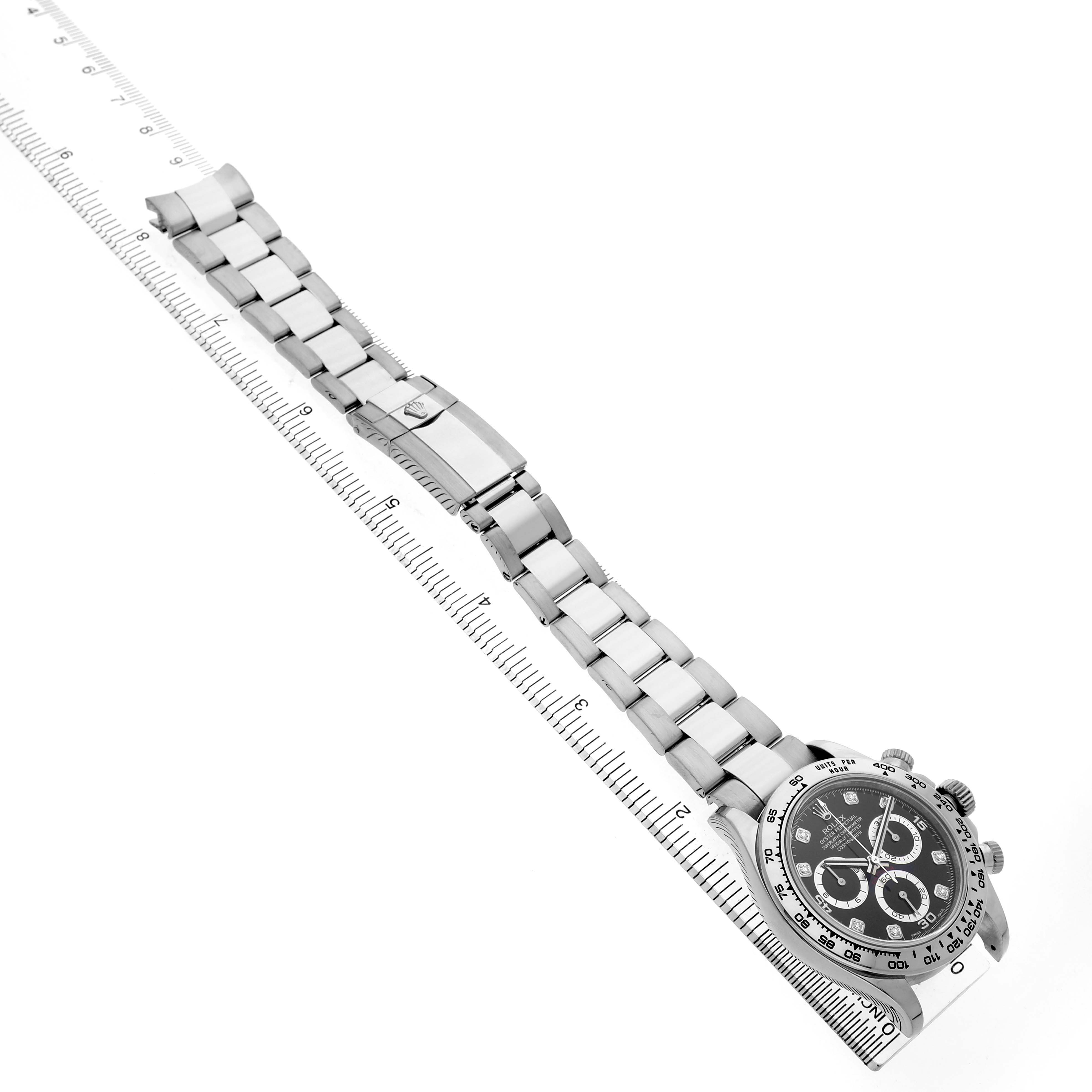 The Rolex Daytona 116509 Men's White Gold Black Dial model is shown at an angled top view, displaying the watch face and full bracelet next to a ruler.