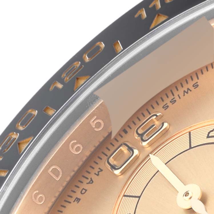 Close-up of the bezel and part of the dial of a Rolex Daytona 116518 Men's Yellow Gold Champagne Dial 116518 Men's Yellow Gold Champagne Dial watch, showing the indices and some markings.