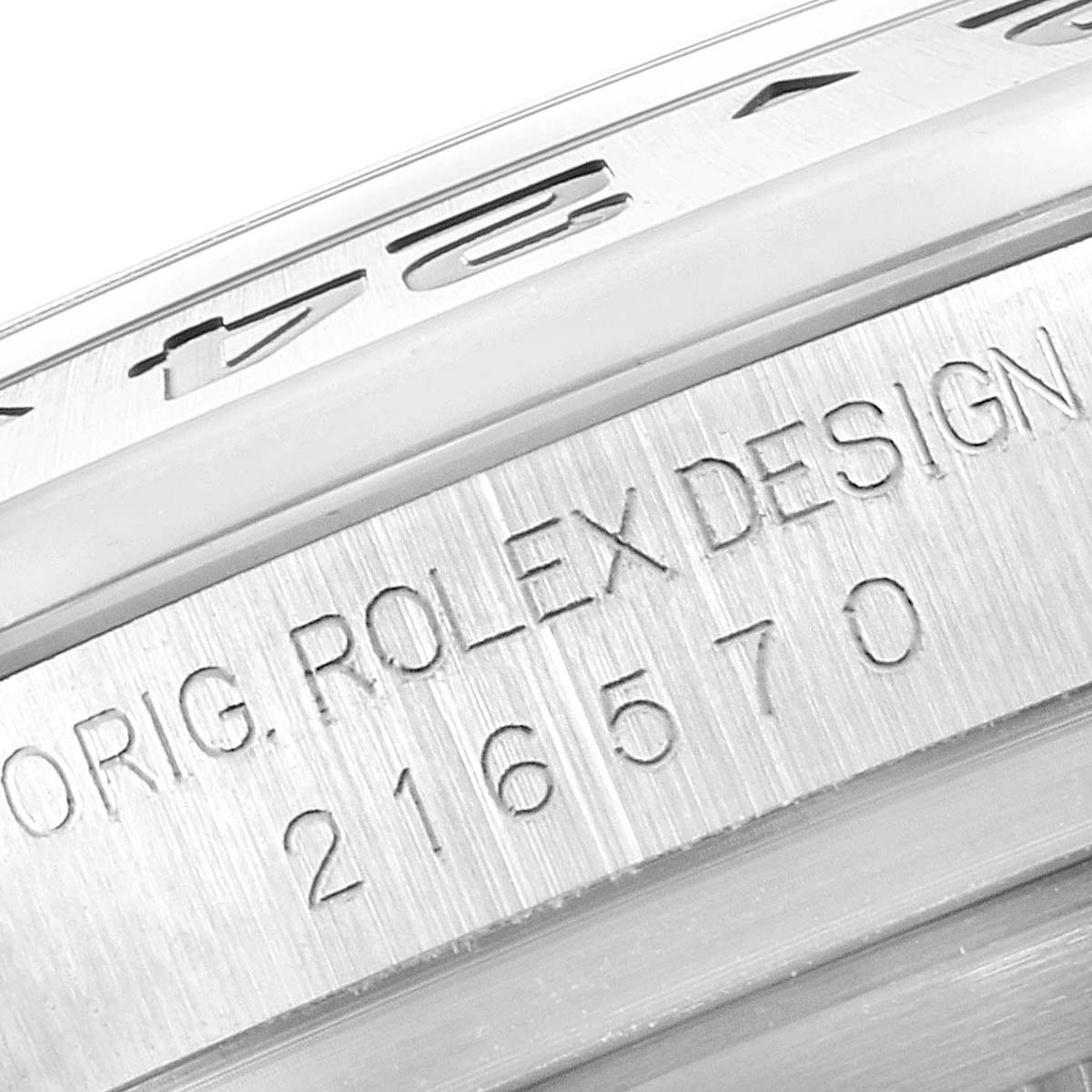 The image shows a close-up of the side engraving on the bezel of a Rolex Explorer 216570 Men's Stainless Steel White Dial 216570 Men's Stainless Steel White Dial model watch.