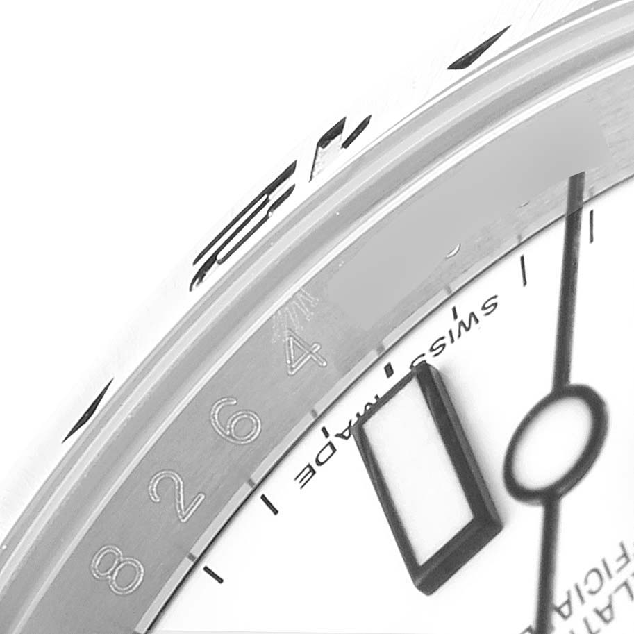 The image shows a close-up of the dial and bezel of a Rolex Explorer 216570 Men's Stainless Steel White Dial 216570 Men's Stainless Steel White Dial watch, highlighting the hour markers and surrounding details.