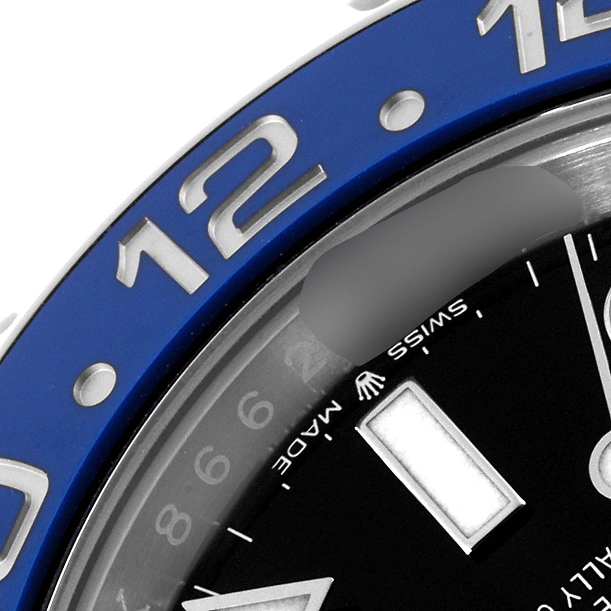 This close-up image of the Rolex GMT-Master 126710 Men
s Stainless Steel Black Dial 126710 Men
s Stainless Steel Black Dial watch shows a portion of the bezel with numerals and part of the dial with Swiss markings.