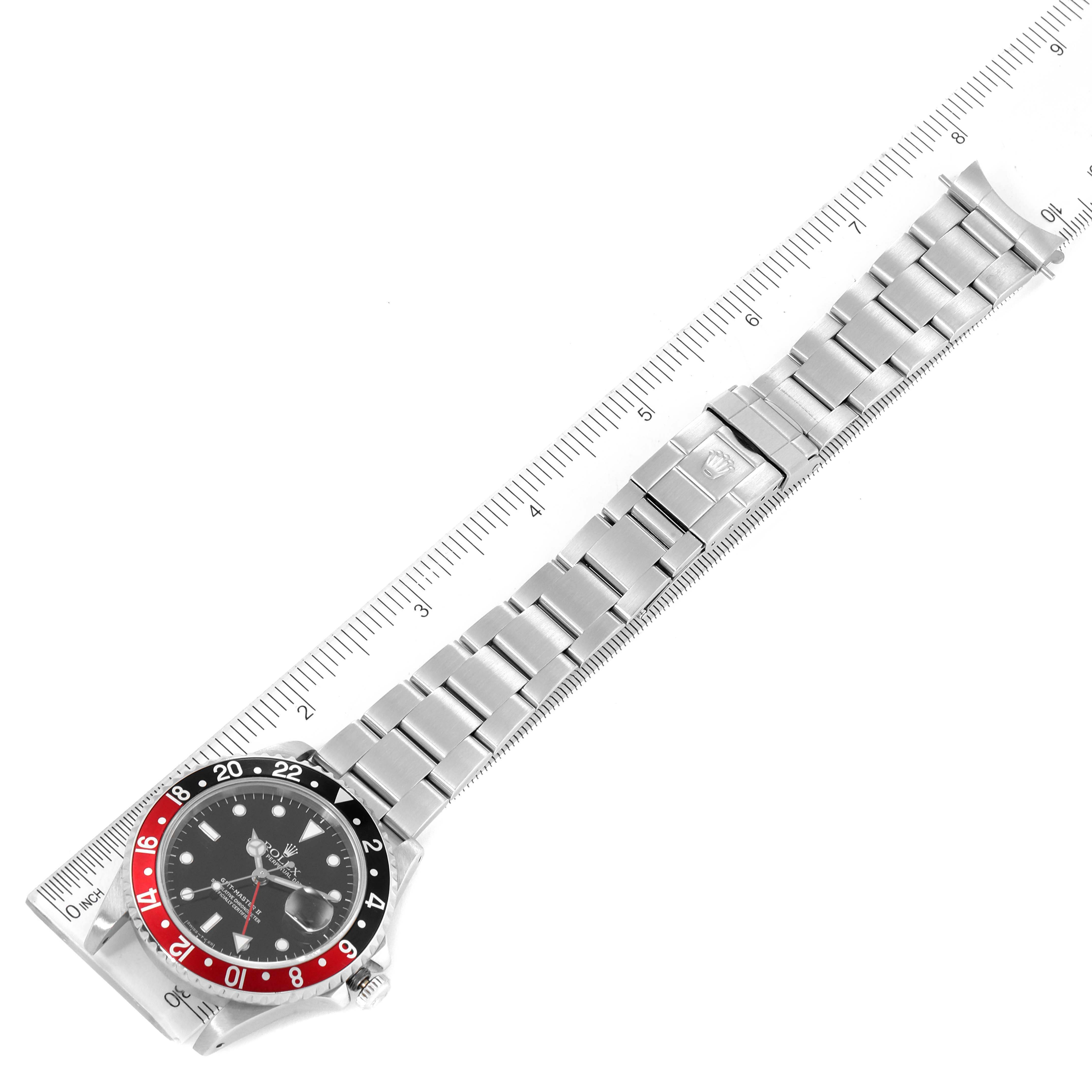 The Rolex GMT-Master 16710 Men's Stainless Steel Black Dial 16710 Men's Stainless Steel Black Dial watch is shown at a slight diagonal angle, displaying the face, bezel, and bracelet against a ruler background.