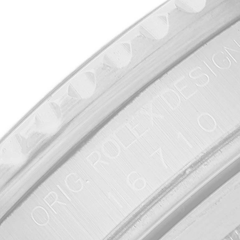 This close-up image shows the engraved inner bezel and part of the rehaut of the Rolex GMT-Master 16710 Men's Stainless Steel Black Dial 16710 Men's Stainless Steel Black Dial watch.