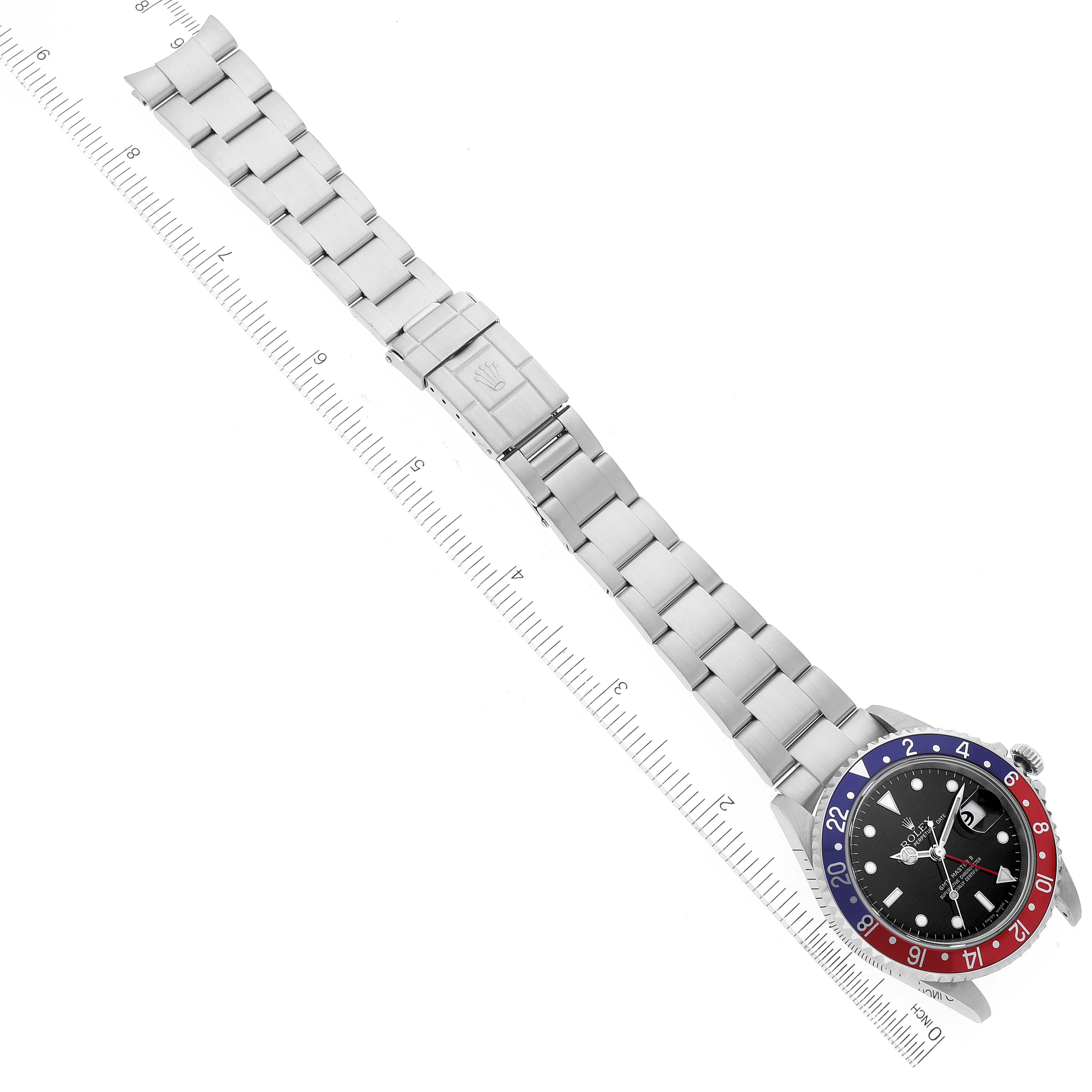 The image shows a top view of a Rolex GMT-Master 16710 Men's Stainless Steel Black Dial 16710 Men's Stainless Steel Black Dial watch, displaying its entire bracelet, clasp, and dial with a red and blue bezel.