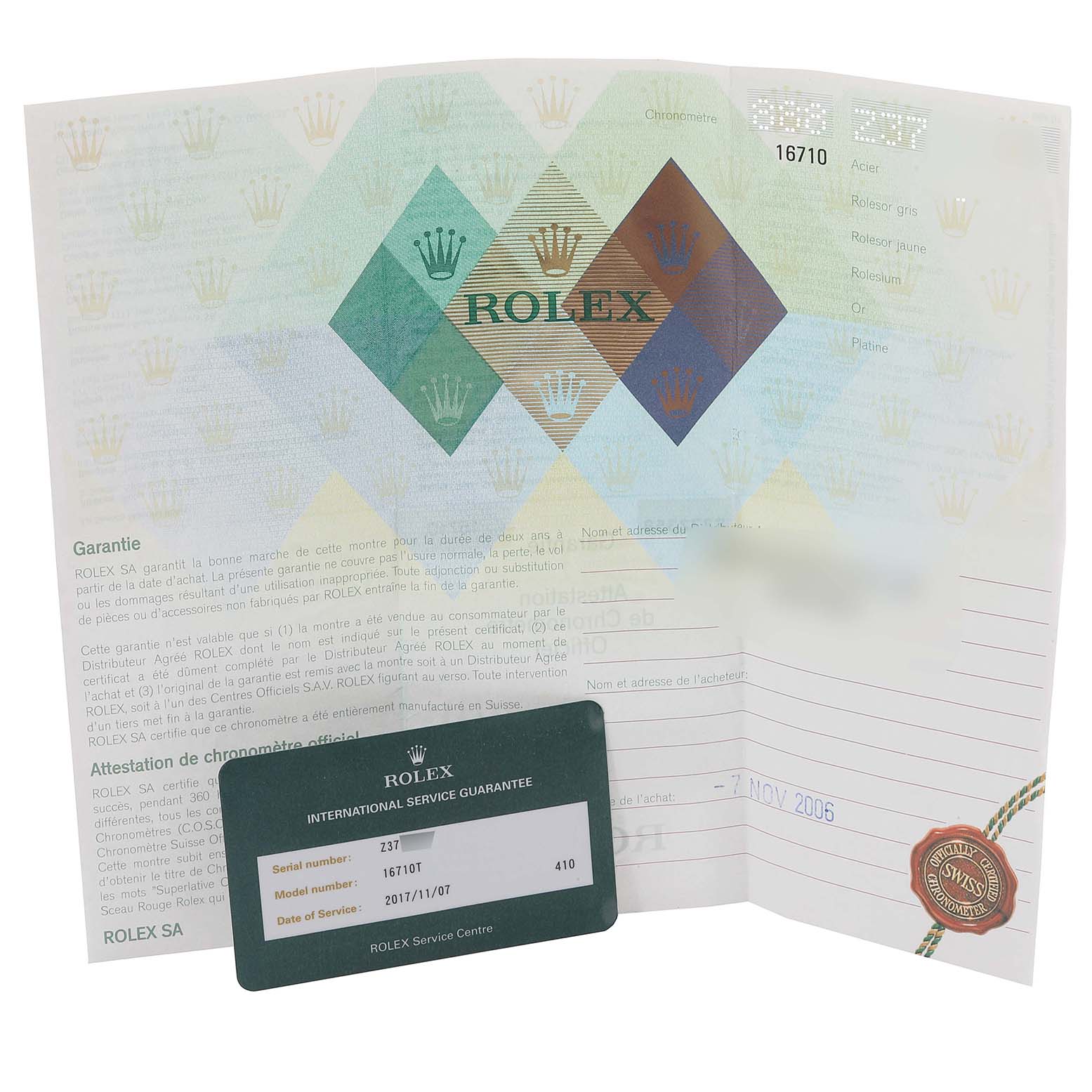 The image shows a Rolex GMT-Master 16710 Men's Stainless Steel Black Dial 16710 Men's Stainless Steel Black Dial warranty card and documentation from a top-down angle.