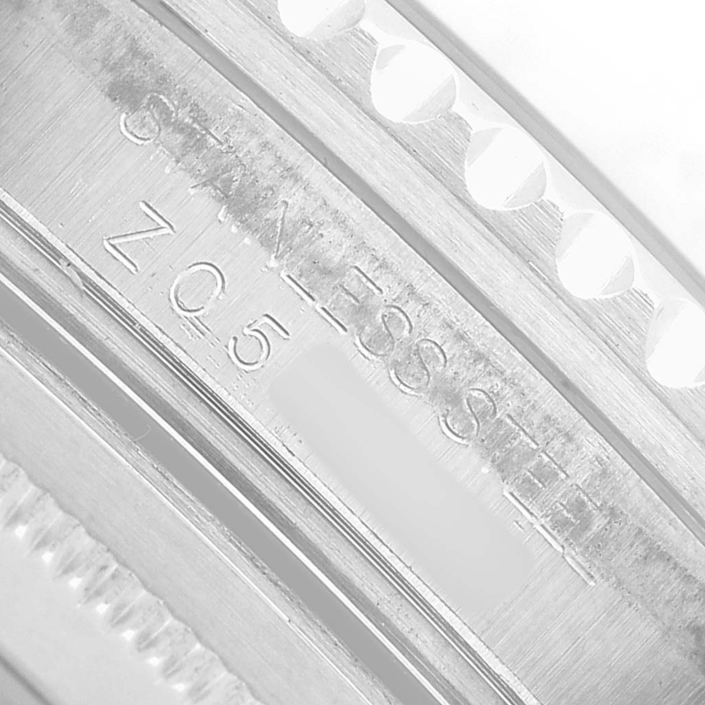 The image shows a close-up of the side engraving on the stainless steel bracelet of a Rolex GMT-Master 16710 Men's Stainless Steel Black Dial watch.