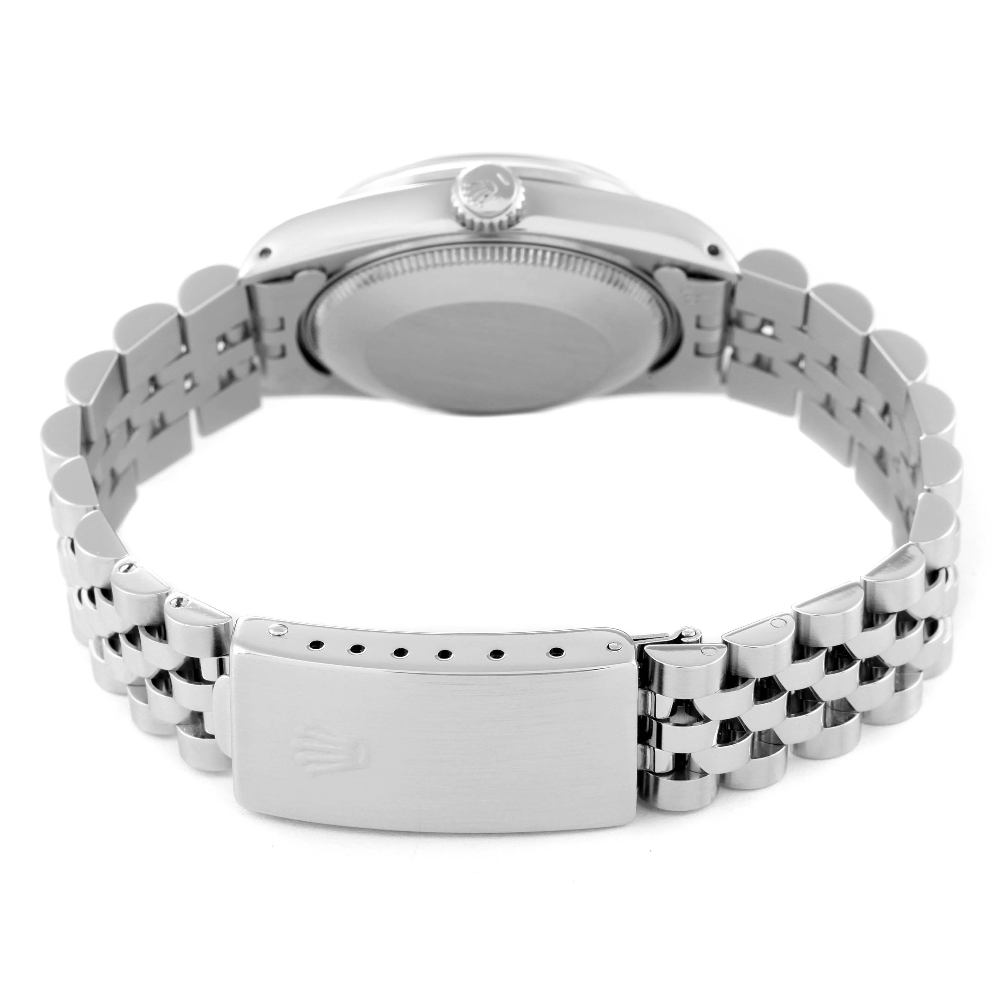 The image shows the backside and clasp of a mid-size Rolex watch in a partly open position.