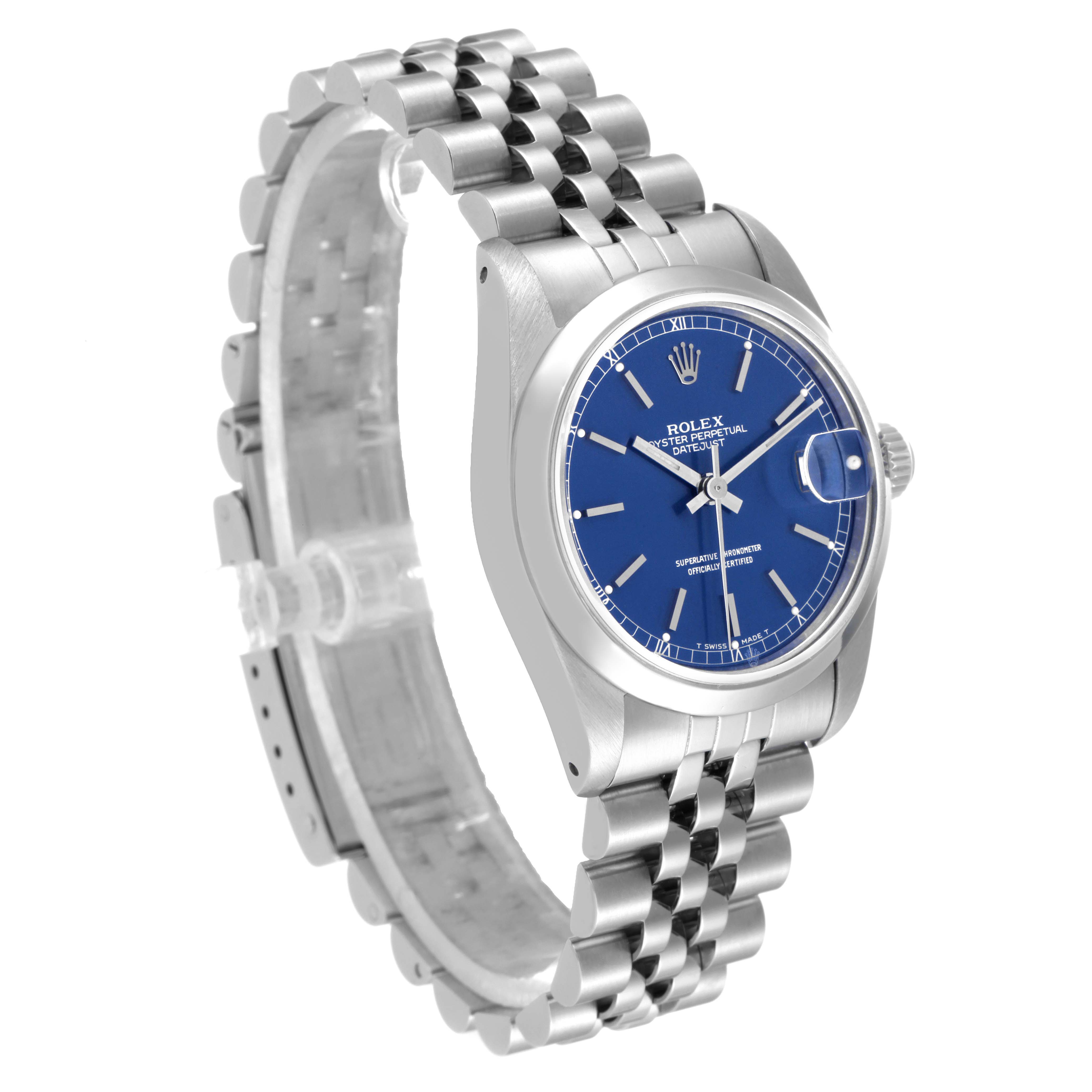 This Rolex Mid-Size 68240 Women
s Stainless Steel Blue Dial 68240 Women
s Stainless Steel Blue Dial watch is shown at an angled side view, highlighting its blue dial, case, and stainless steel bracelet.