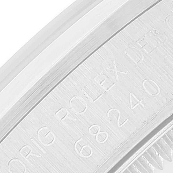 The image shows a close-up of the engraved caseback edge of a Rolex Mid-Size 68240 Women
s Stainless Steel Blue Dial 68240 Women
s Stainless Steel Blue Dial model watch.