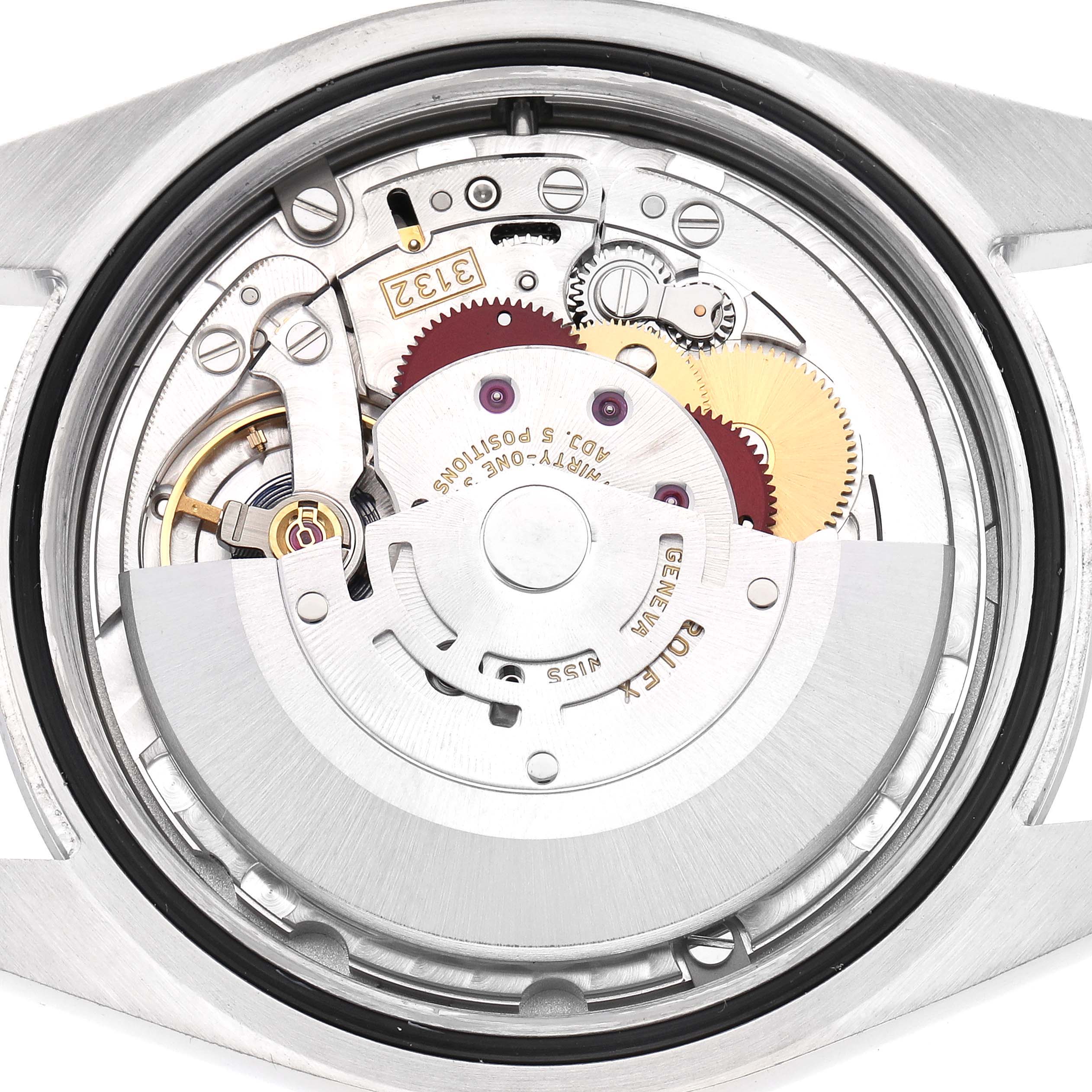 The image shows the movement of a Rolex Oyster Perpetual 114300 Men
s Stainless Steel Black Dial 114300 Men
s Stainless Steel Black Dial watch from a back, internal angle, revealing gears and the rotor.