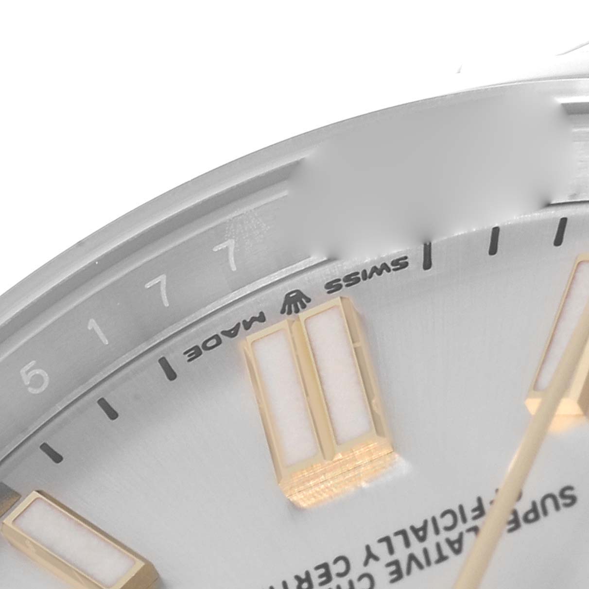 This close-up image of the Rolex Oyster Perpetual 124300 Men's Stainless Steel Silver Dial 124300 Men's Stainless Steel Silver Dial watch displays part of the dial, indices, and "Swiss Made" text.