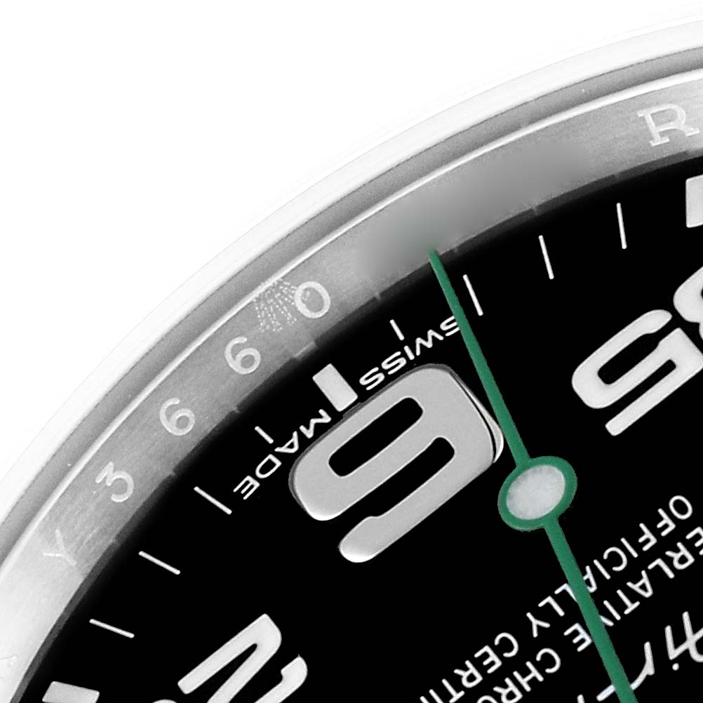 The image shows a close-up of the dial's upper left section of the Rolex Air-King 116900 Men's Stainless Steel Black Dial 116900 Men's Stainless Steel Black Dial, focusing on the 9 o'clock marker and part of the green second hand.