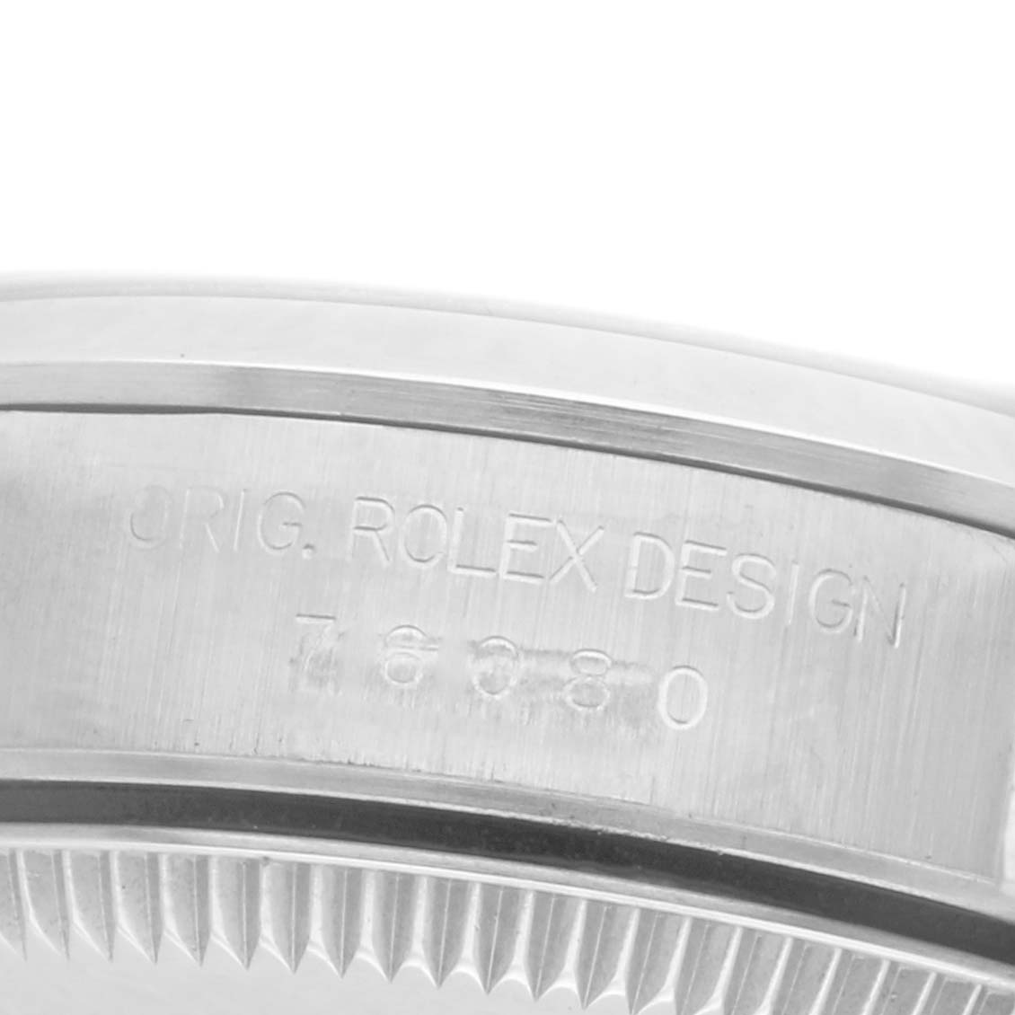 The image shows the engraved side of the case of an Oyster Perpetual Rolex watch.