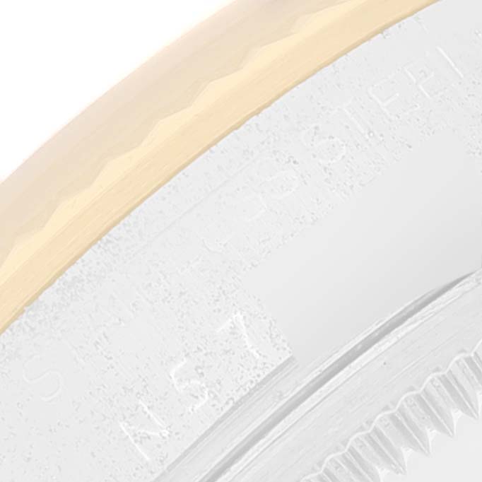 This close-up angle shows the bezel and part of the case of a Rolex Oyster Perpetual 14233 Men's Steel and Gold (two tone) Champagne Dial 14233 Men's Steel and Gold (two tone) Champagne Dial watch.