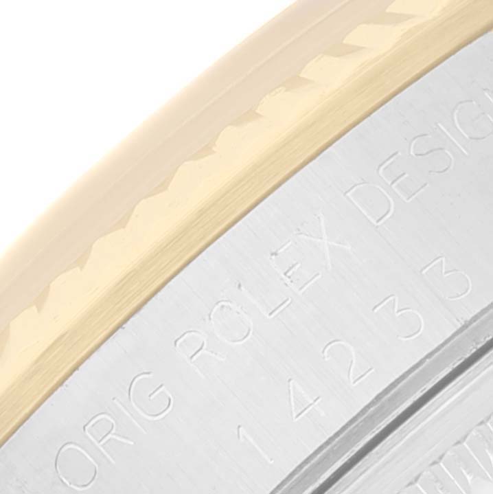 This image shows a close-up of the side engraving and bezel of a Rolex Oyster Perpetual 14233 Men's Steel and Gold (two tone) Champagne Dial 14233 Men's Steel and Gold (two tone) Champagne Dial watch.