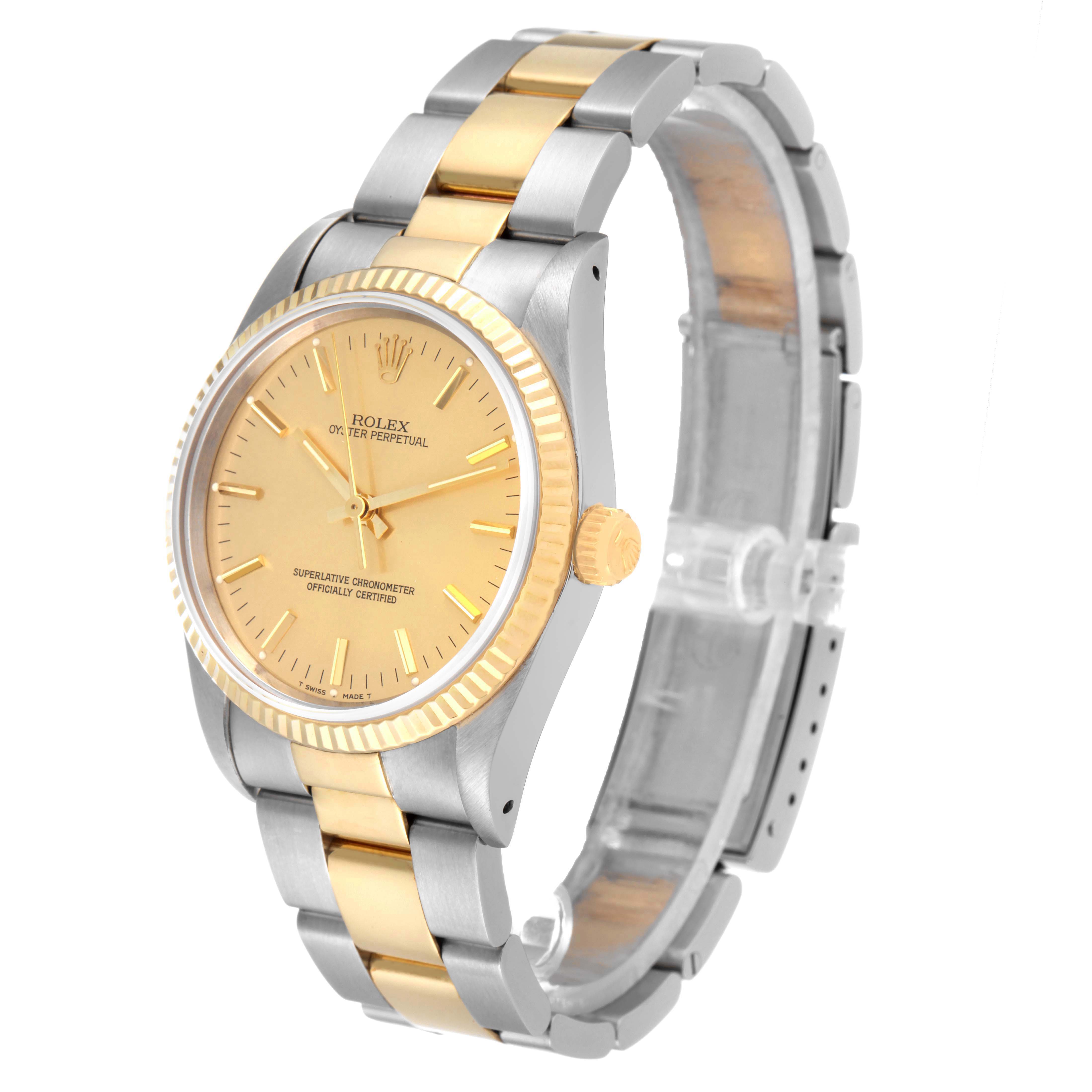 This image shows a Rolex Oyster Perpetual 14233 Men's Steel and Gold (two tone) Champagne Dial 14233 Men's Steel and Gold (two tone) Champagne Dial watch at a slight angle, highlighting its two-tone bracelet, bezel, and face.