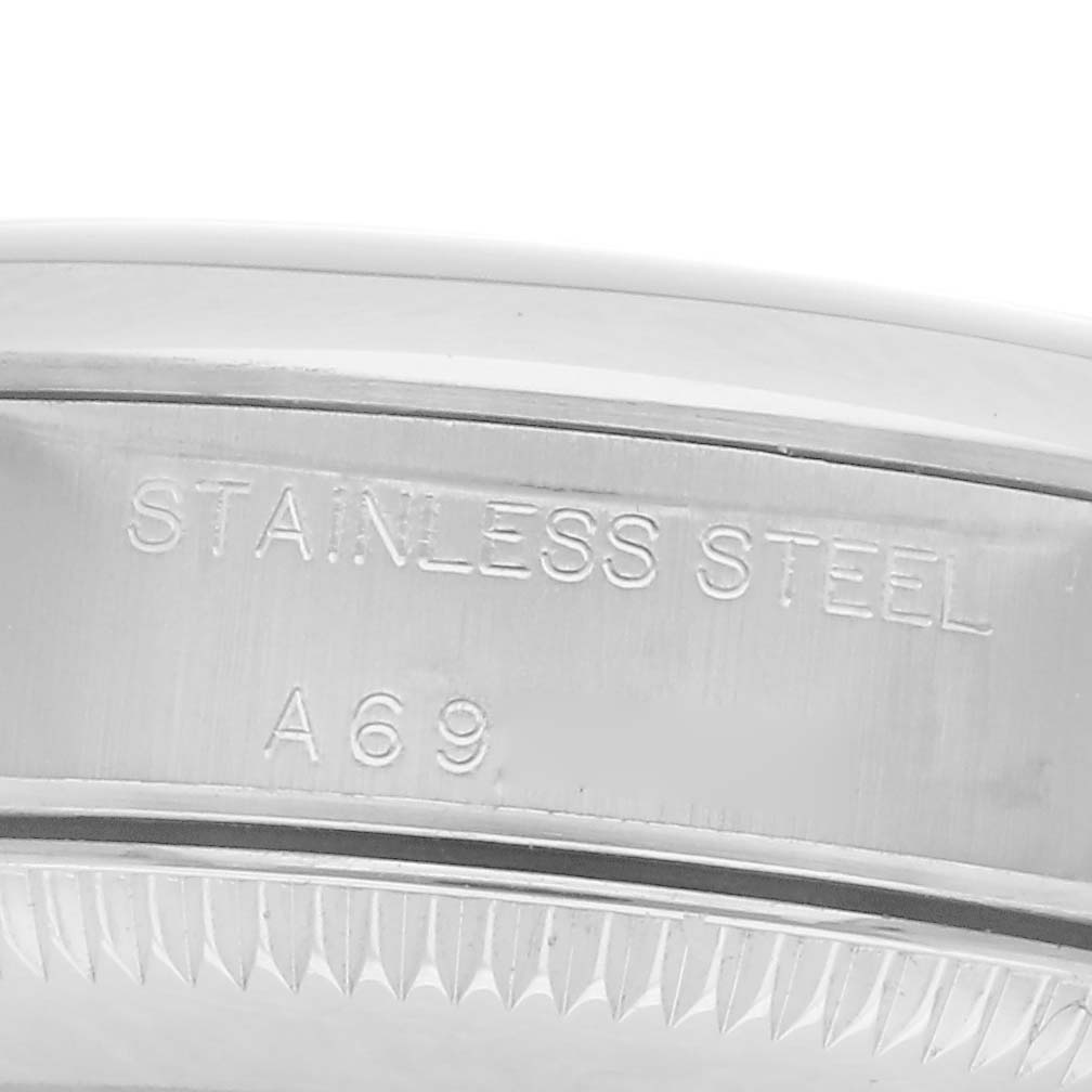 The image shows a close-up of the engraved side of the stainless steel case of a Rolex Oyster Perpetual 76080 Women
s Stainless Steel Pink Dial 76080 Women
s Stainless Steel Pink Dial watch.
