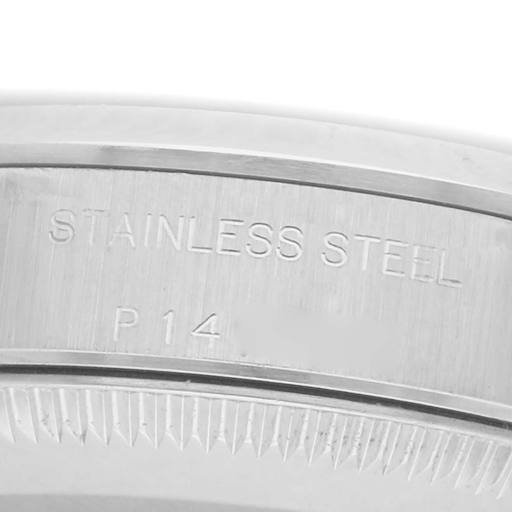 The image shows a close-up of the Rolex Oyster Perpetual 76080 Women
s Stainless Steel Pink Dial 76080 Women
s Stainless Steel Pink Dial
s stainless steel case edge and engraving.