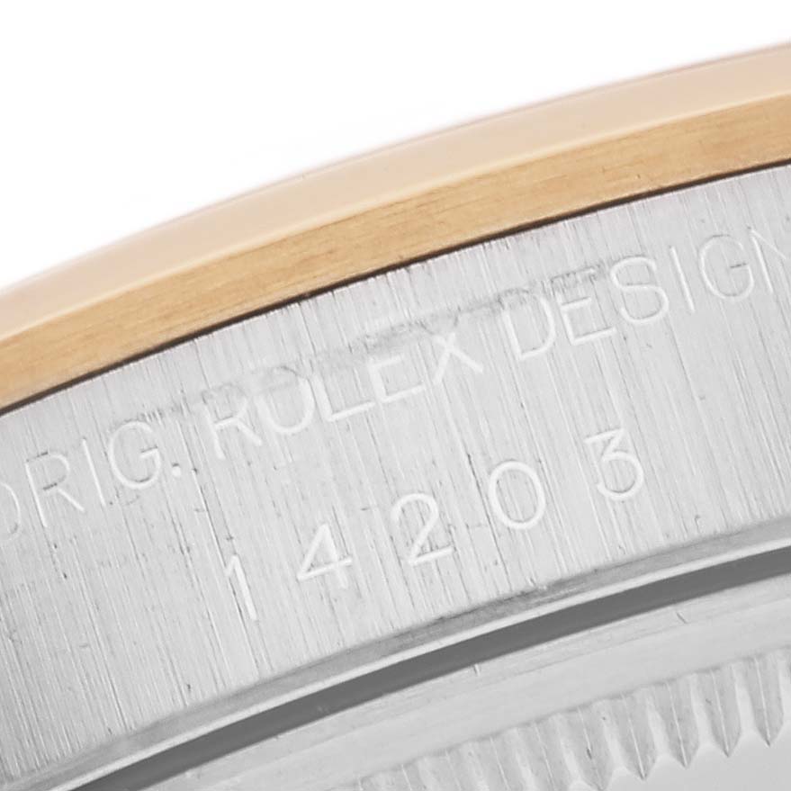 The image shows a close-up of the side of the bezel and engraved serial number on a Rolex Oyster Perpetual 14203 Men's Steel and Gold (two tone) Grey Dial 14203 Men's Steel and Gold (two tone) Grey Dial watch.