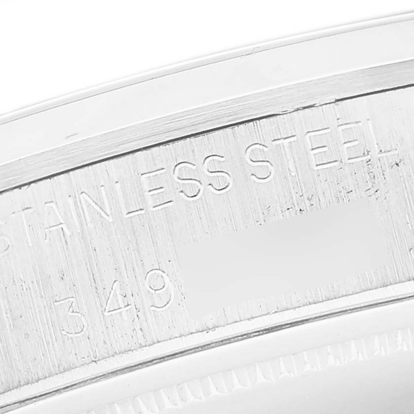 The image shows a close-up of the inner rim of the Rolex Vintage Collection 6694 Men's Stainless Steel Silver Dial 6694 Men's Stainless Steel Silver Dial watch with engraved details.