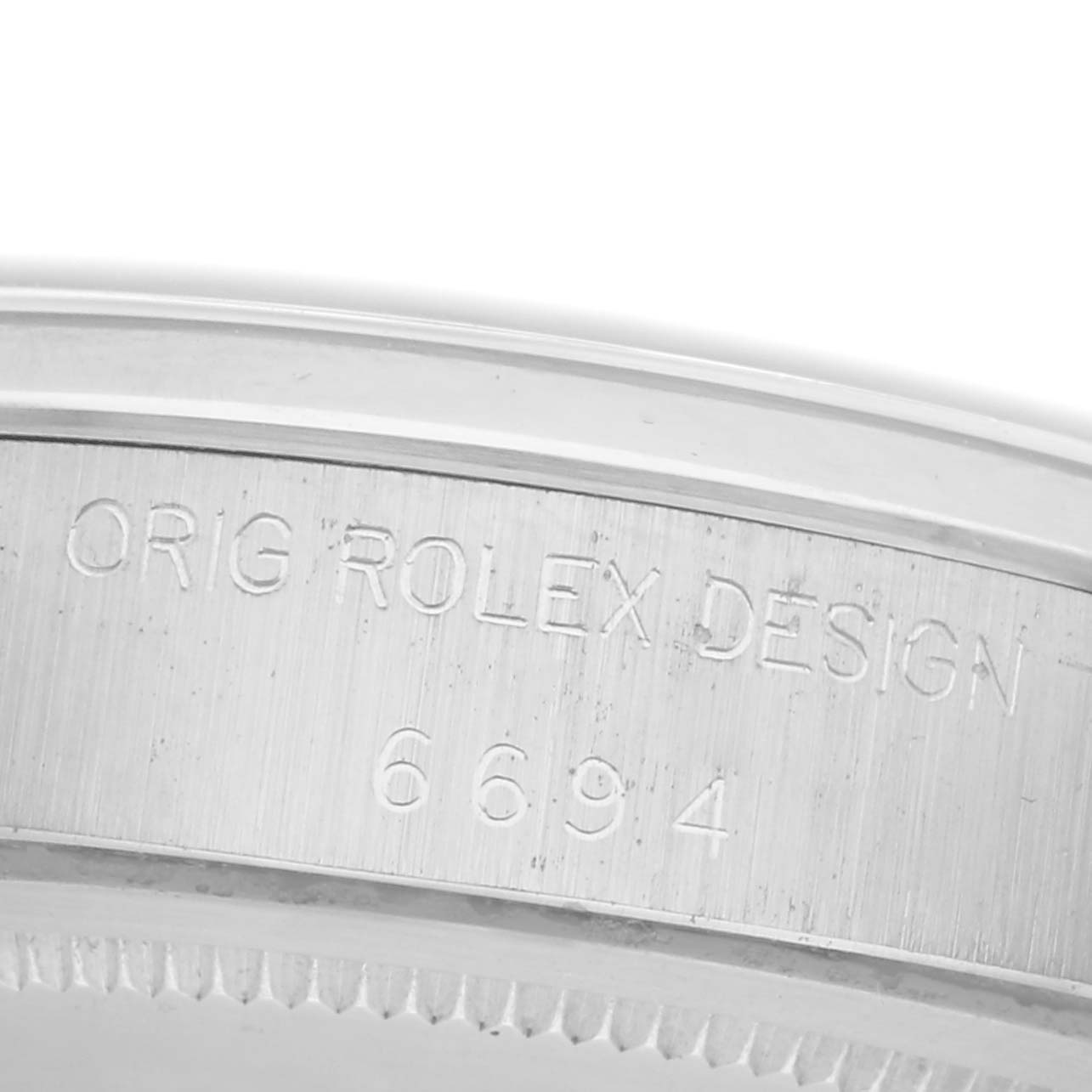 The image shows a close-up of the case edge of a Rolex Vintage Collection 6694 Men
s Stainless Steel Silver Dial 6694 Men
s Stainless Steel Silver Dial watch, highlighting its engraved model details.