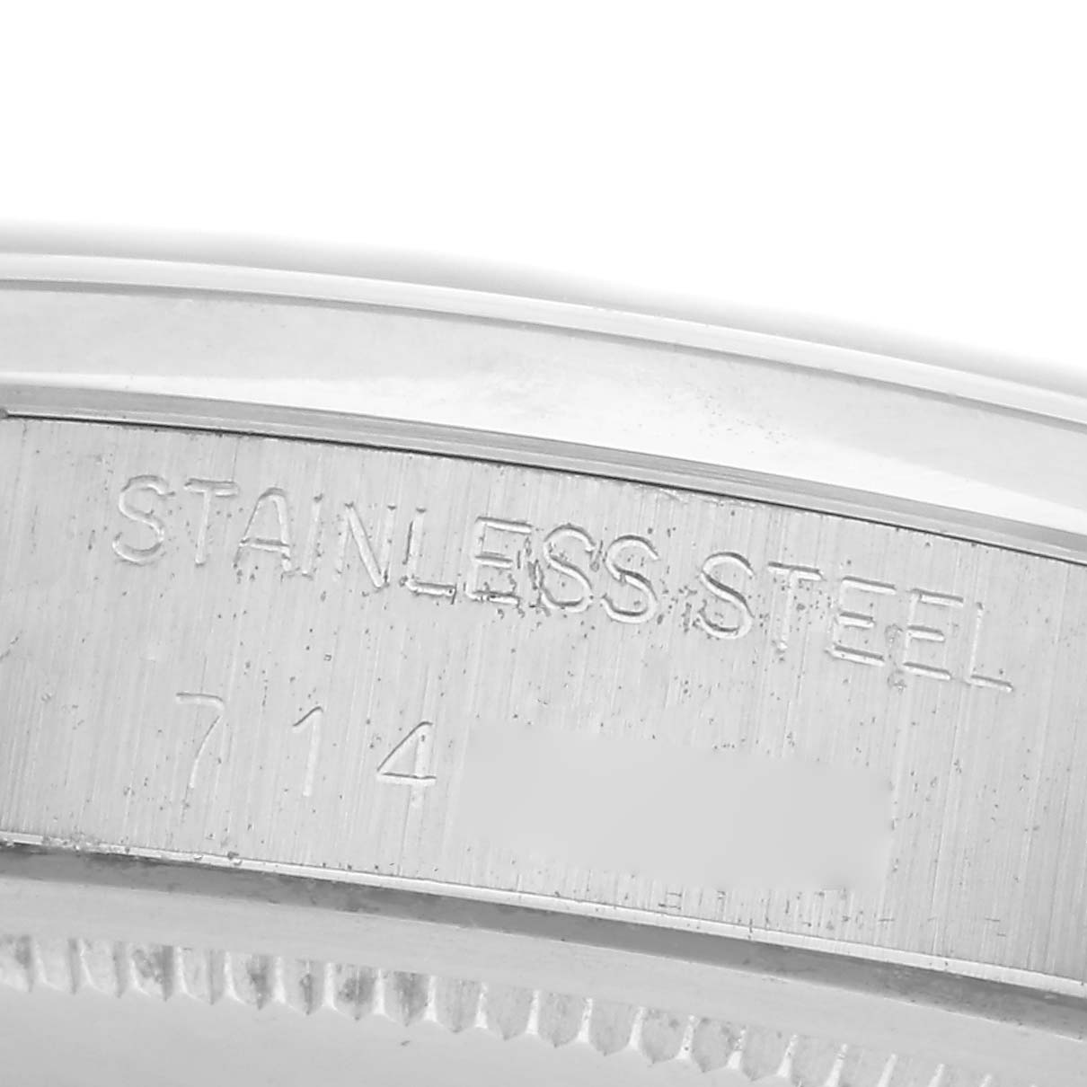 The image shows a close-up of the stainless steel case back engraving on a Rolex Vintage Collection 6694 Men
s Stainless Steel Silver Dial 6694 Men
s Stainless Steel Silver Dial watch.