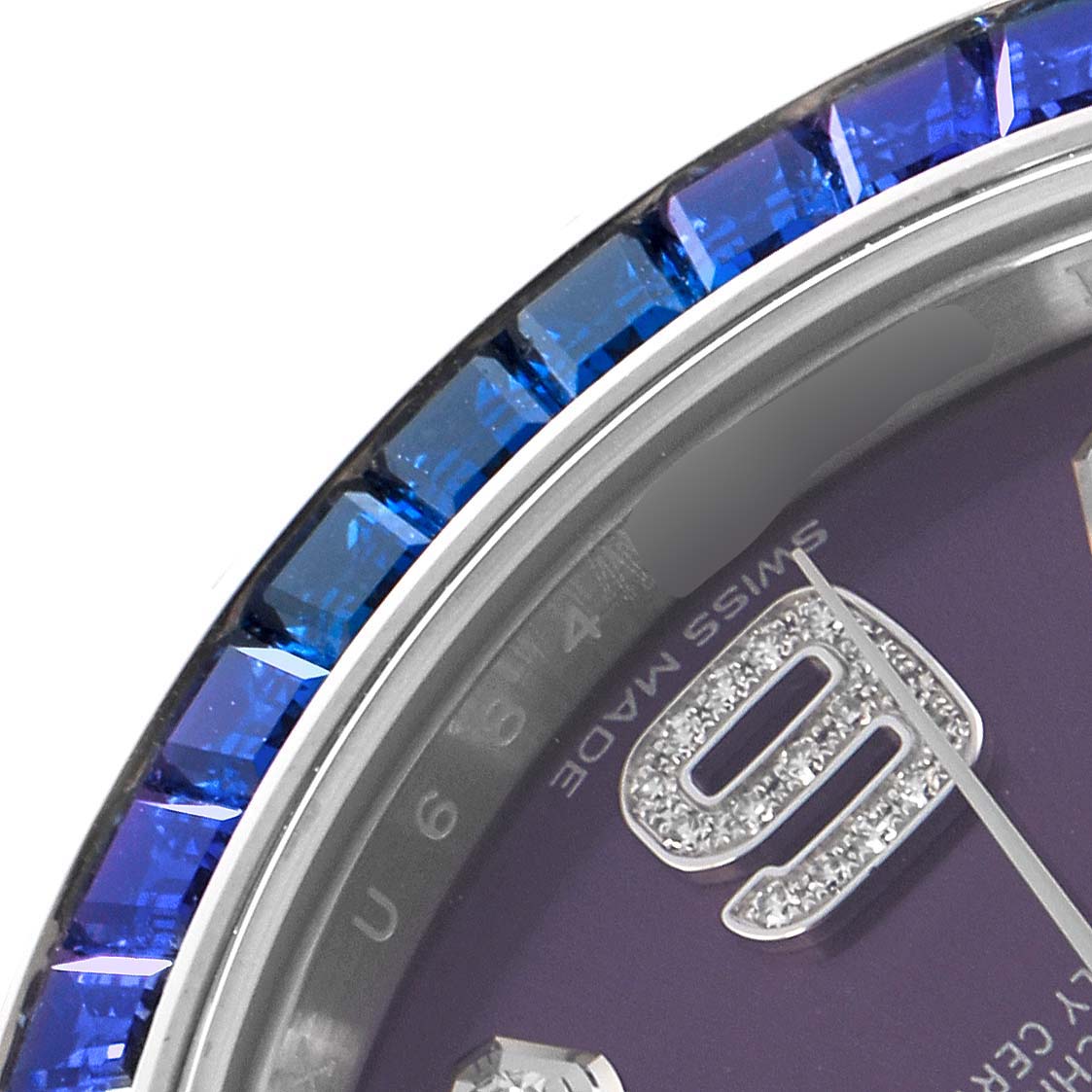 The image shows a close-up of the bezel and part of the dial of a Rolex Pearlmaster 86349SAFUBL Men
s White Gold Red Dial 86349SAFUBL Men
s White Gold Red Dial watch, highlighting blue gemstones and a numeral.