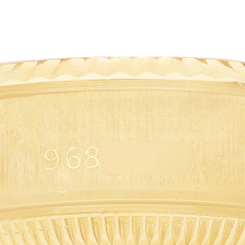 The image shows a close-up of a gold bezel and case with markings on a Rolex President 69178 Women's Yellow Gold Champagne Dial model watch.