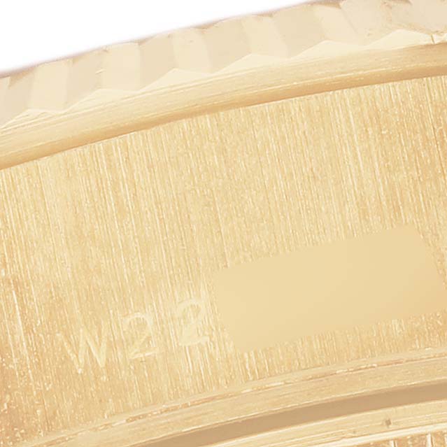 The image shows a close-up of the engraved inner band of a Rolex President 69178 Women's Yellow Gold Champagne Dial watch, highlighting its textured surface.