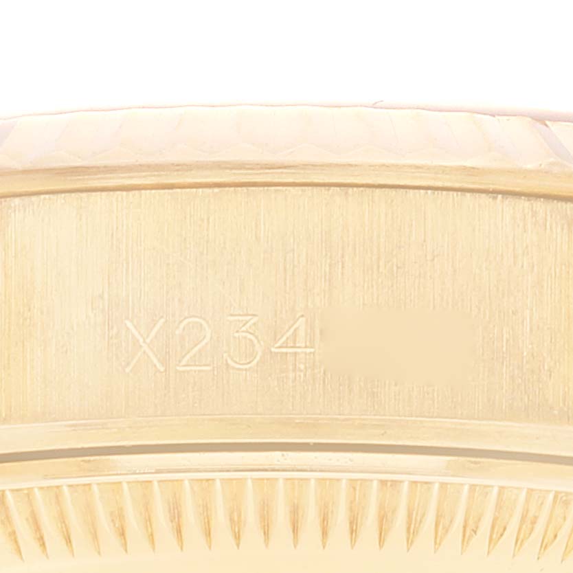 This image shows a partial close-up view of the case side and engraved serial number of a Rolex President 69178 Women
s Yellow Gold Champagne Dial 69178 Women
s Yellow Gold Champagne Dial model watch.