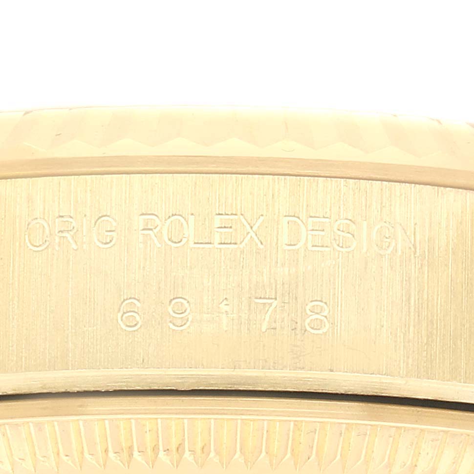 The image shows a close-up of the serial number engraving on the case of a Rolex President 69178 Women's Yellow Gold Champagne Dial 69178 Women's Yellow Gold Champagne Dial watch.