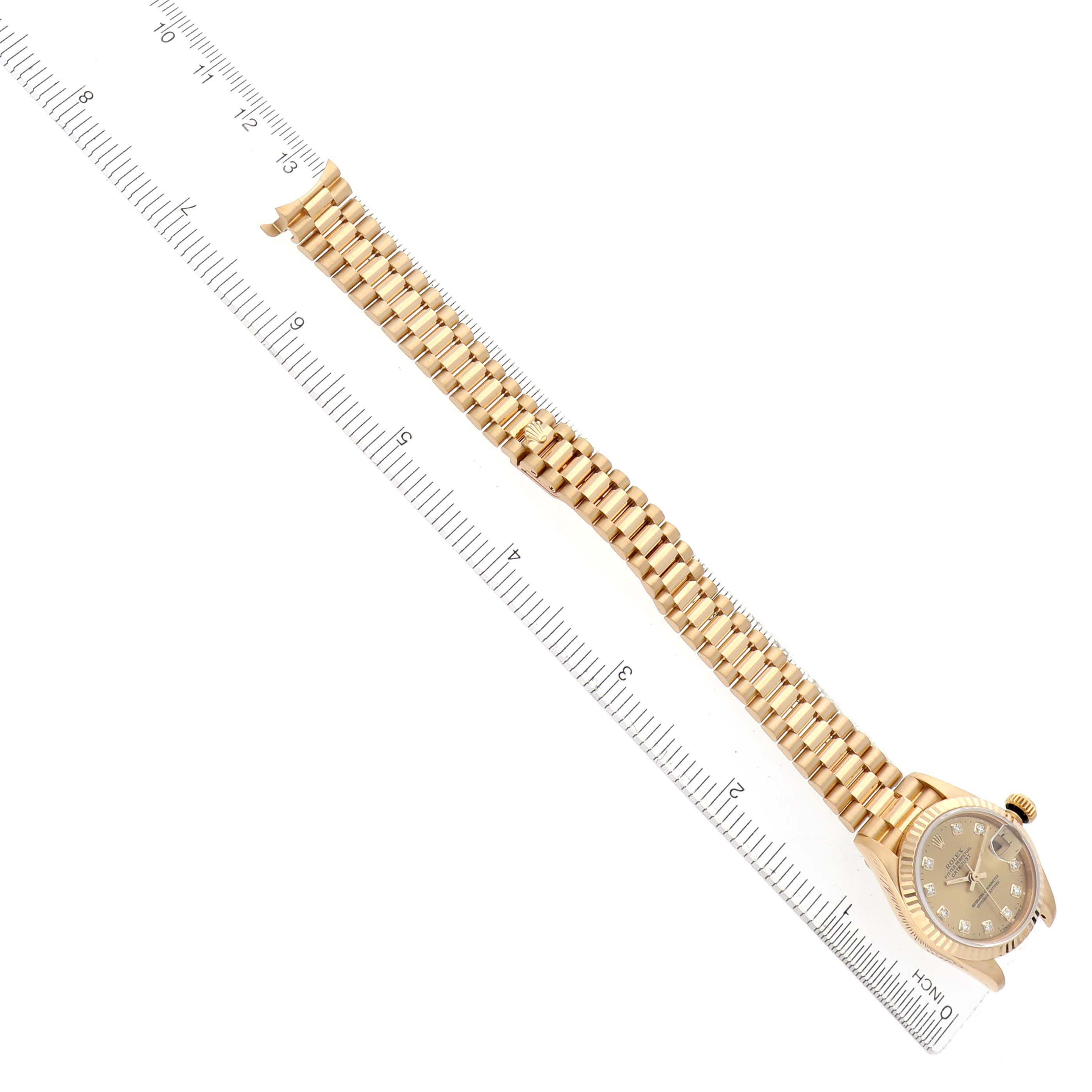 The image shows a Rolex President 69178 Women's Yellow Gold Champagne Dial 69178 Women's Yellow Gold Champagne Dial model watch with a full view of the bracelet and face, positioned diagonally with a ruler alongside.