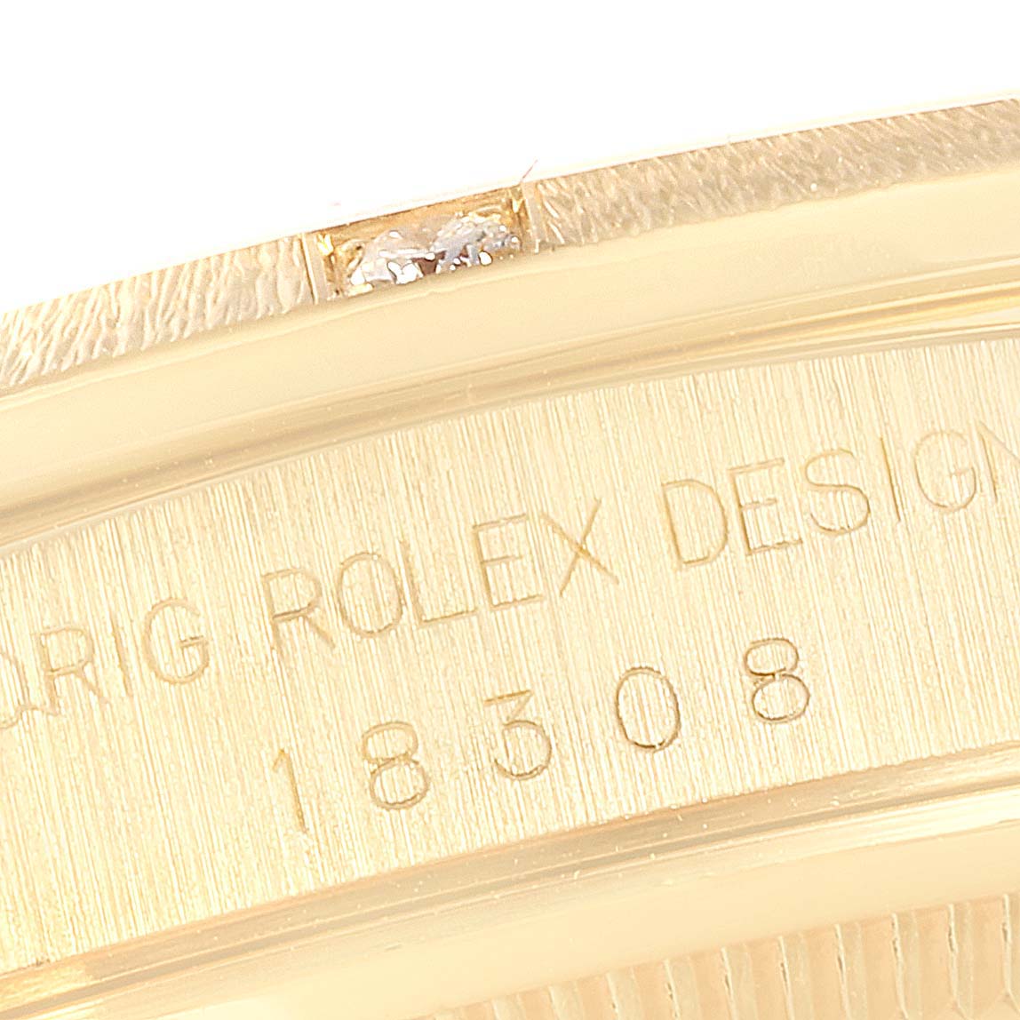 This close-up image shows the model number engraving on the side of a Rolex President 18308 Men
s Yellow Gold Champagne Dial 18308 Men
s Yellow Gold Champagne Dial watch case.
