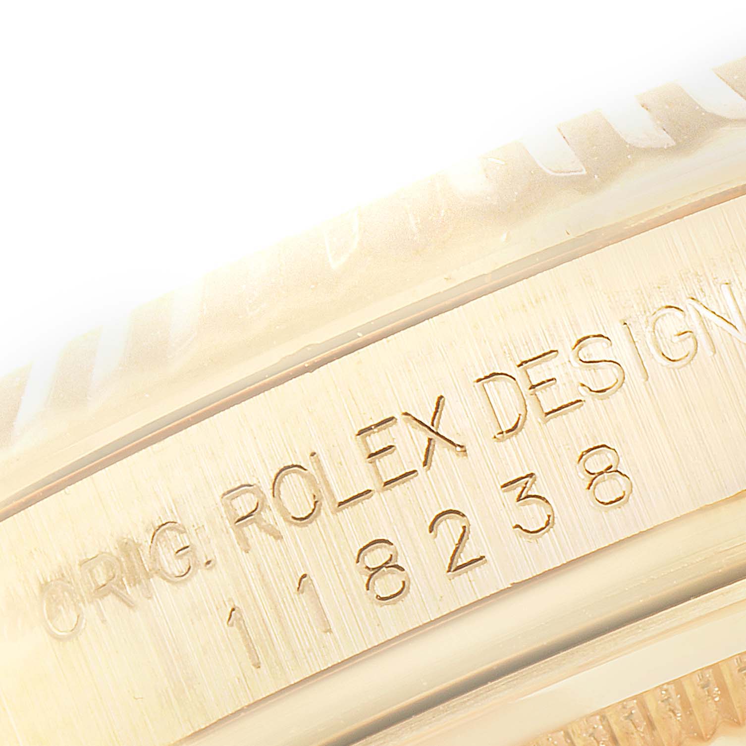 The image shows a close-up angle of the side of the Rolex President 118238 Men's Yellow Gold Black Dial 118238 Men's Yellow Gold Black Dial model, highlighting the engraved serial and design numbers.