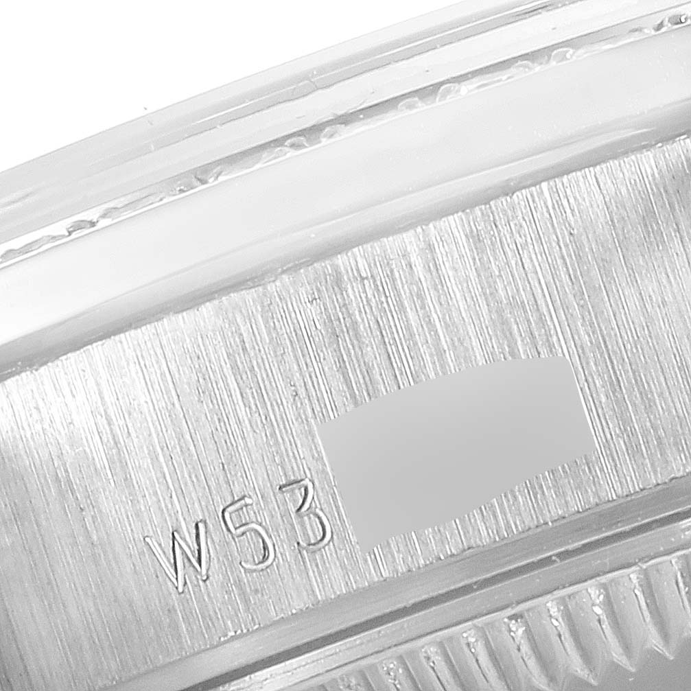 The image shows a close-up of the side of a Rolex President 69136 Women's Platinum Silver Dial 69136 Women's Platinum Silver Dial model watch, focusing on the serial number engraving.