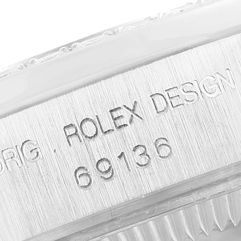 This image shows an angled close-up of the case back with "Rolex Design" and model number of a Rolex President 69136 Women's Platinum Silver Dial 69136 Women's Platinum Silver Dial watch.
