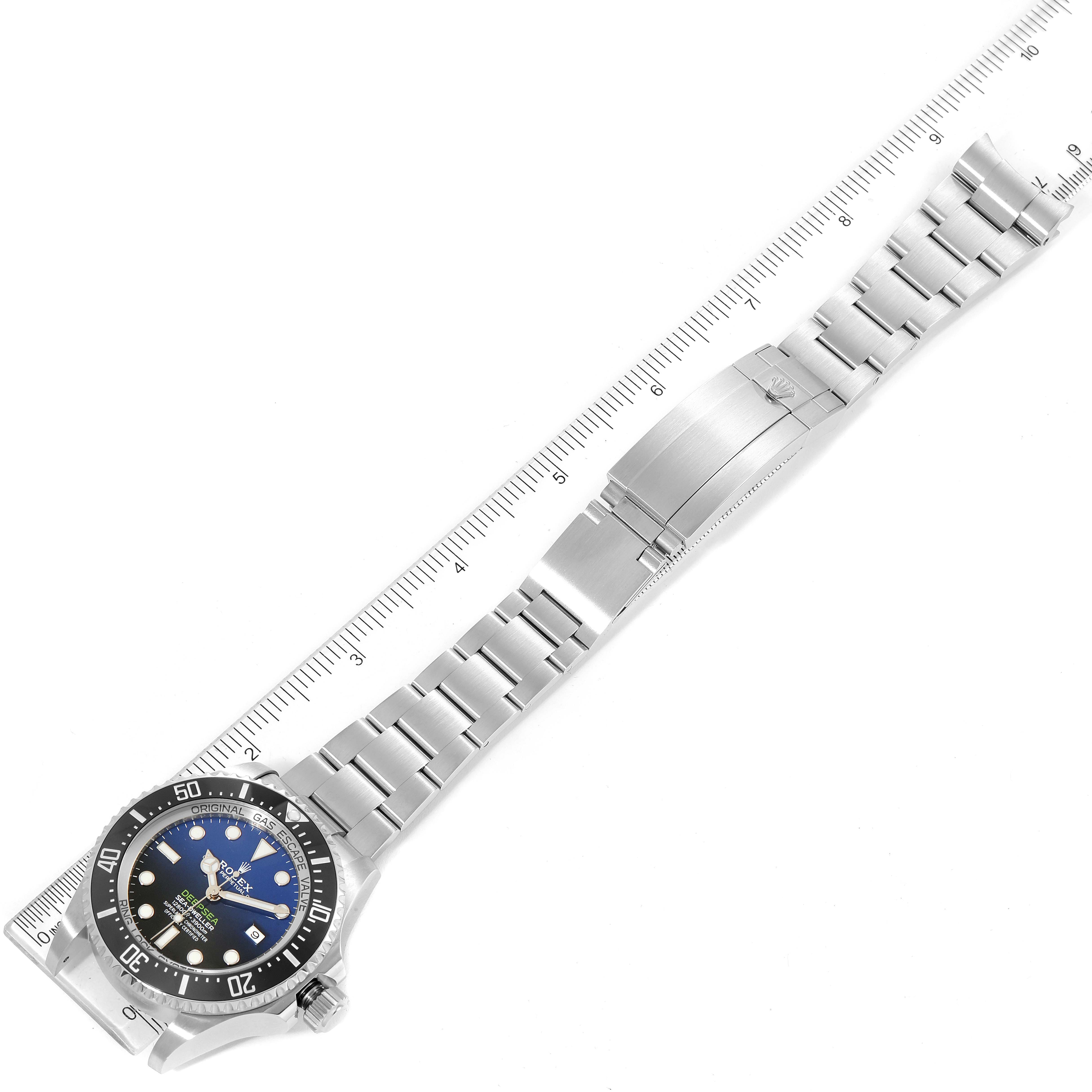 The image shows the Rolex Sea-Dweller 126660 Men
s Stainless Steel Blue Dial 126660 Men
s Stainless Steel Blue Dial watch laid flat, displaying the face, bezel, bracelet, clasp, and a ruler for scale.