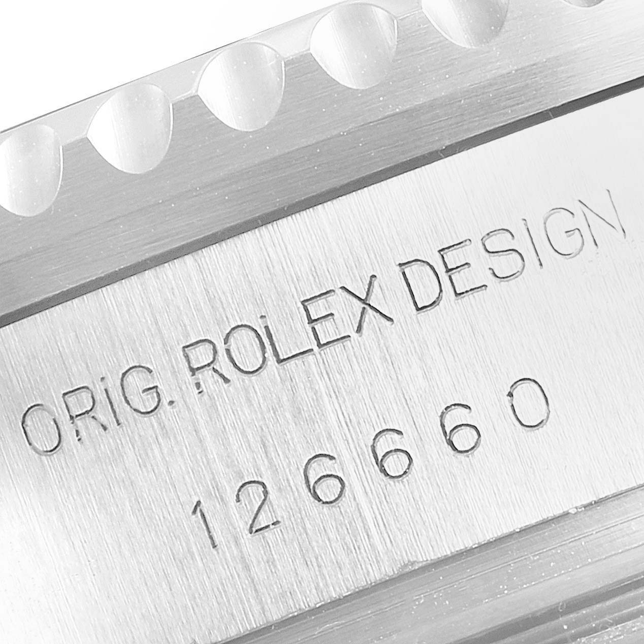 The image shows a close-up of the side of the bezel and the casing with engravings on the Rolex Sea-Dweller 126660 Men
s Stainless Steel Blue Dial 126660 Men
s Stainless Steel Blue Dial watch.