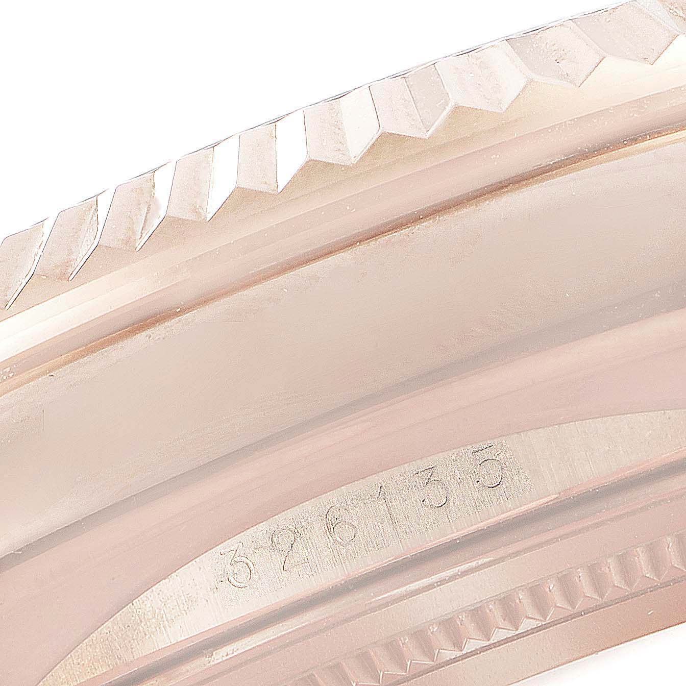 This image shows a close-up of the serial number and fluted bezel on a Rolex Sky-Dweller 326135 Men's Rose Gold Brown Dial 326135 Men's Rose Gold Brown Dial watch.