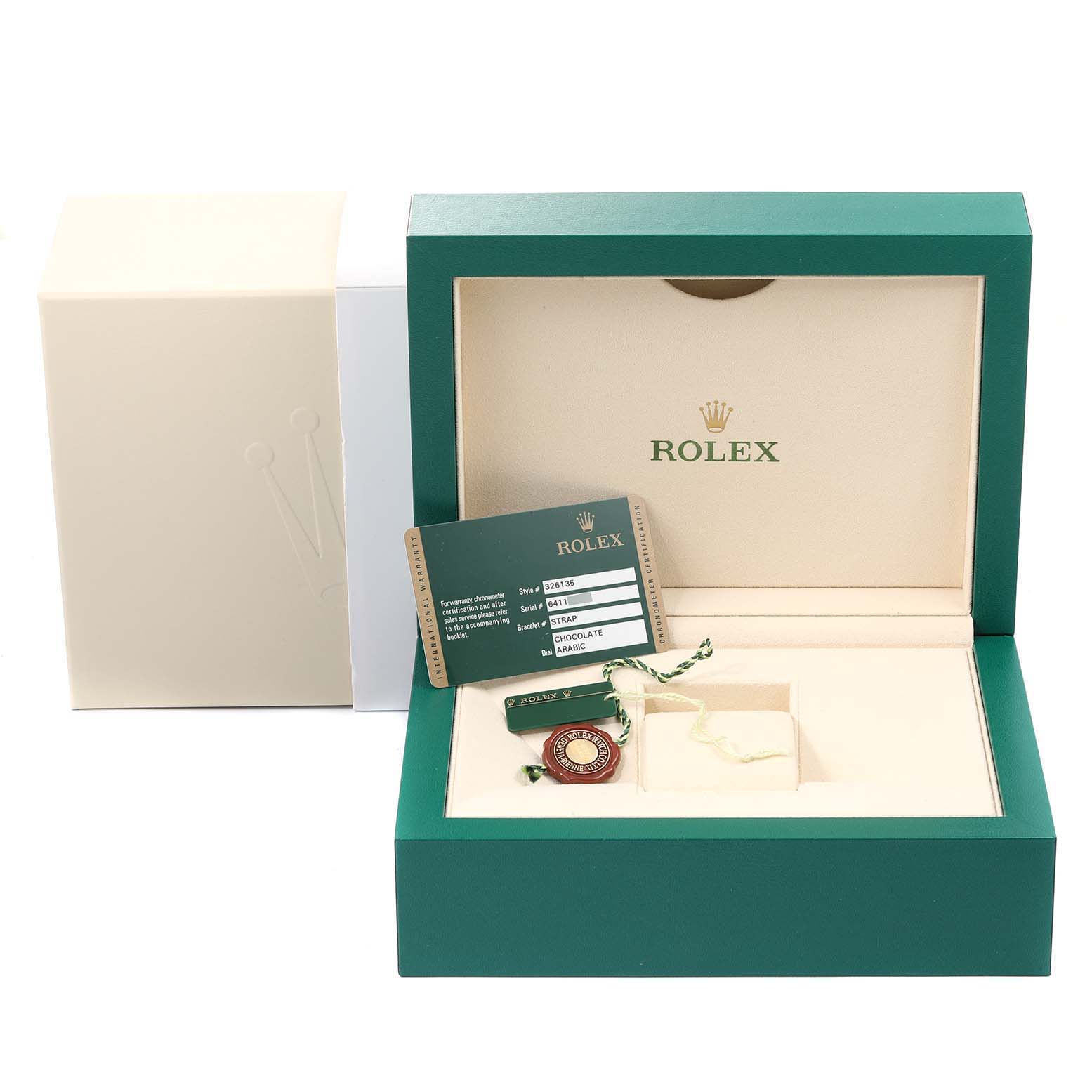 This image shows the packaging and accessories for a Rolex Sky-Dweller 326135 Men's Rose Gold Brown Dial 326135 Men's Rose Gold Brown Dial watch, including the box, warranty card, and tag.
