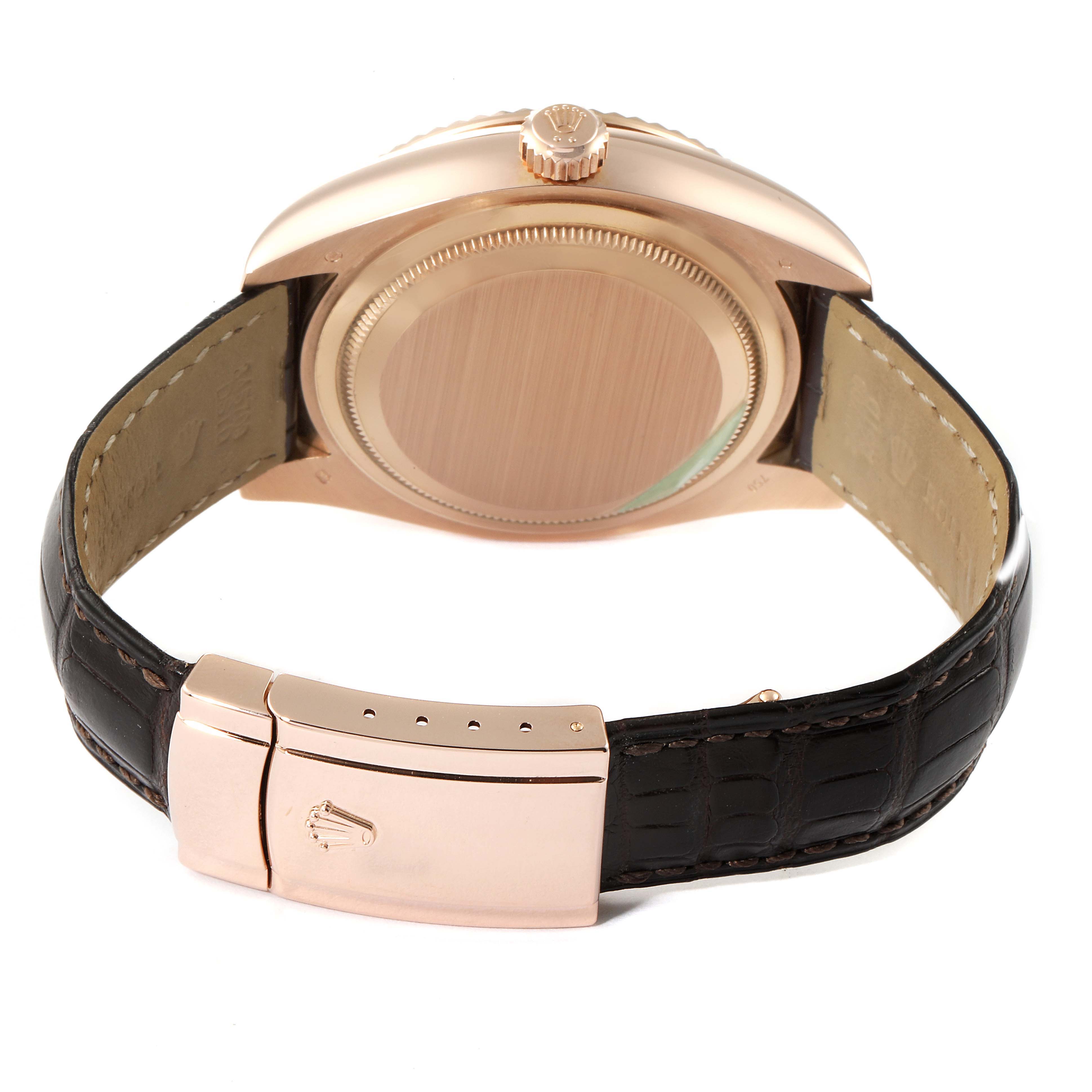 The image shows the back of a Rolex Sky-Dweller 326135 Men's Rose Gold Brown Dial 326135 Men's Rose Gold Brown Dial watch including its case and leather strap with clasp.