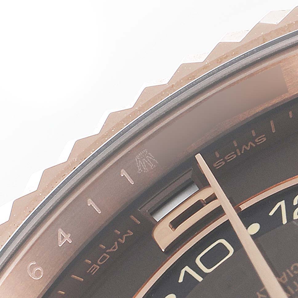 This close-up shows the bezel, dial, and part of the hour hand of the Rolex Sky-Dweller 326135 Men's Rose Gold Brown Dial 326135 Men's Rose Gold Brown Dial.