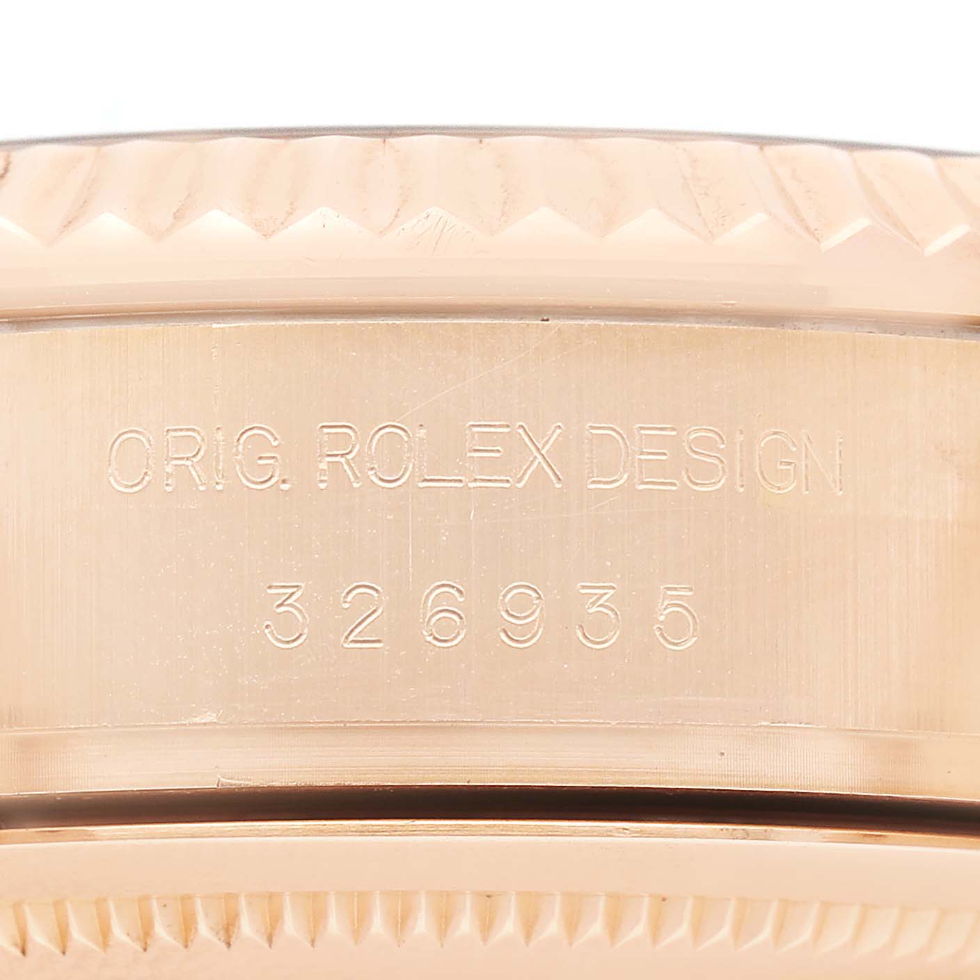 The image shows a close-up of the case edge and engraving on the side of the Rolex Sky-Dweller 326935 Men's Rose Gold Pink Dial watch.